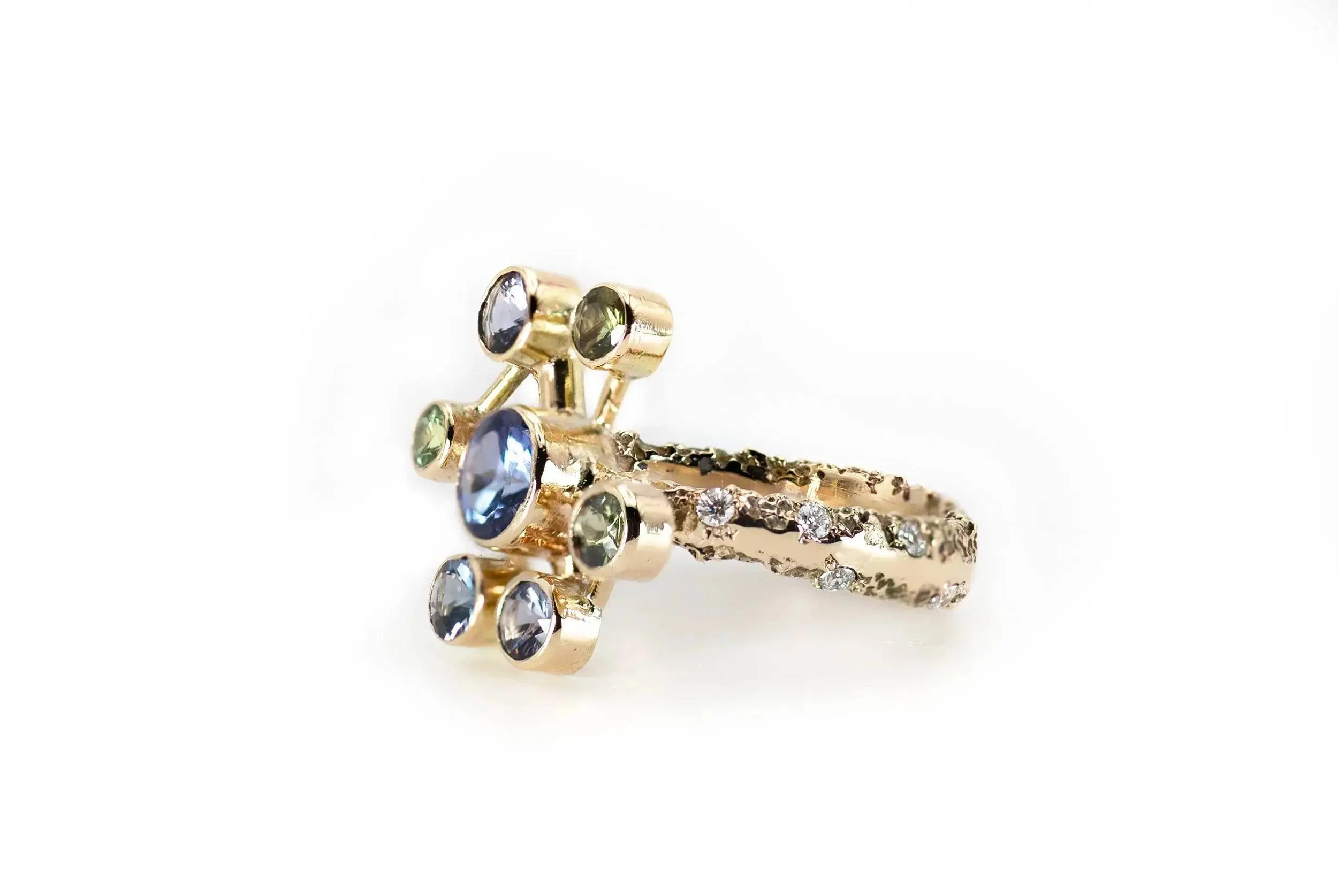 Atomium Ring No. 8 by Iain Sainsbury, 9ct SMO gold sandcast with Cornish Serpentine sand, set with Tanzanite, Sapphires, and Ocean Diamonds.