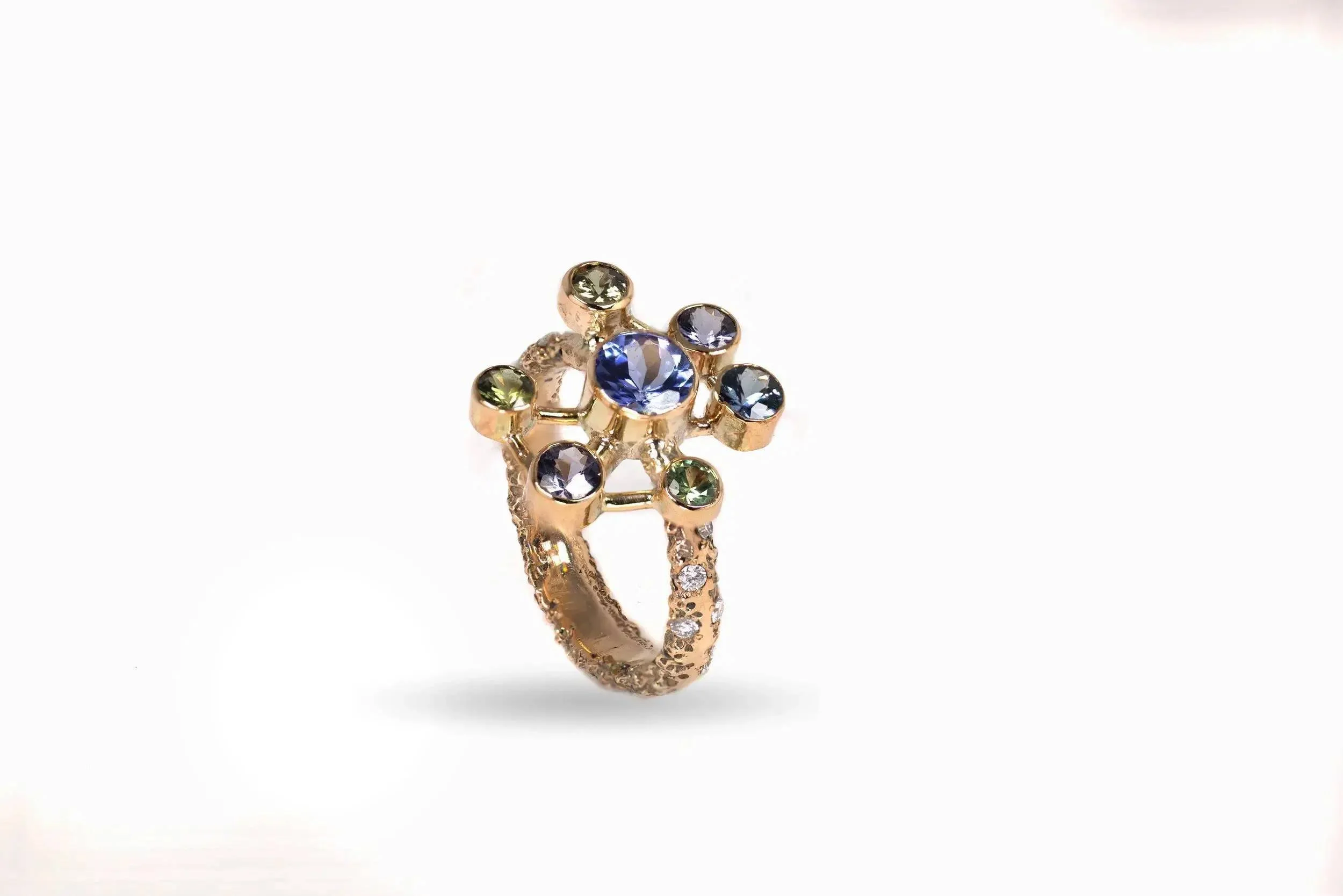 Atomium Ring No. 8 by Iain Sainsbury, 9ct SMO gold sandcast with Cornish Serpentine sand, set with Tanzanite, Sapphires, and Ocean Diamonds.