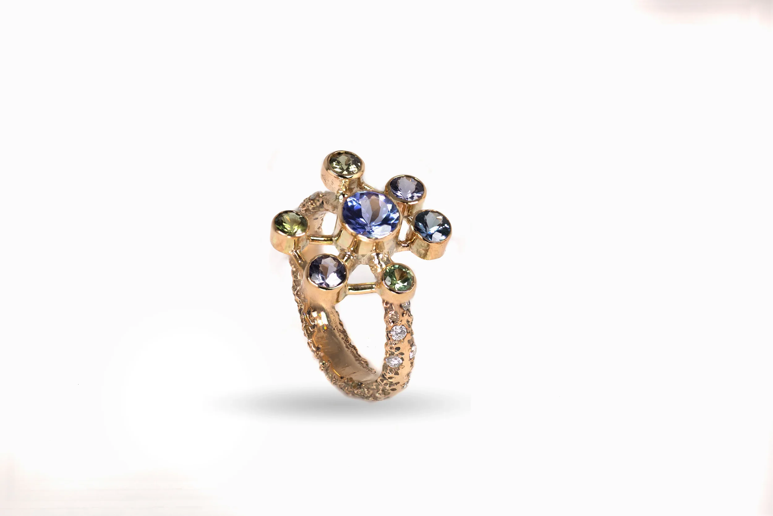 Atomium Ring No. 8 by Iain Sainsbury, 9ct SMO gold sandcast with Cornish Serpentine sand, set with Tanzanite, Sapphires, and Ocean Diamonds.