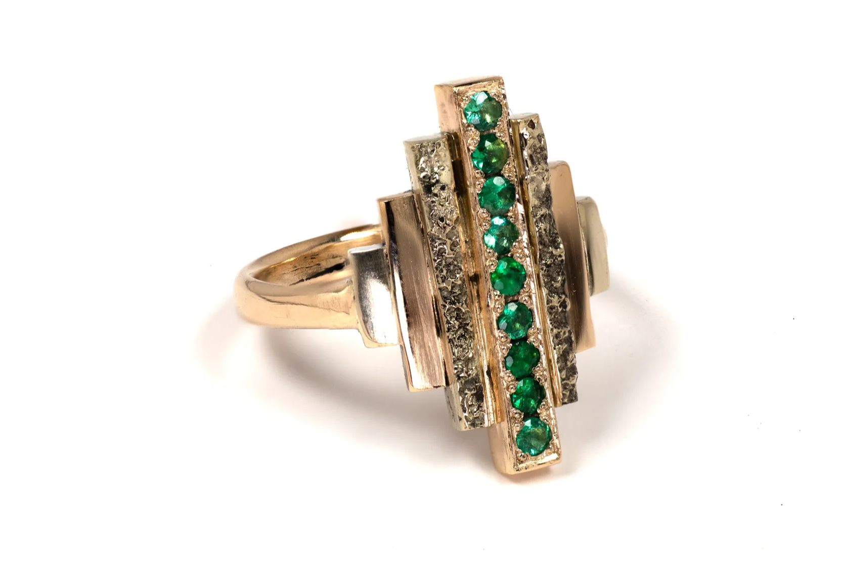METROPOLIS Ring 3: An architectural multi-stone (Brazillian Emeralds) ring uniting raw sandcast gold texture with Machine Age geometric precision. Handcrafted by Iain Sainsbury.