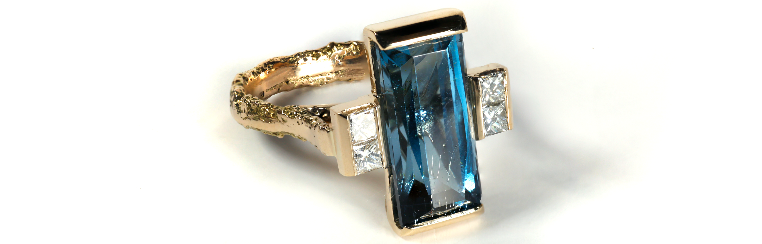 14ct gold Art Deco statement ring featuring a 7.51ct Patrice Spec London Blue Topaz and raw Cornish sandcast shank by Iain Sainsbury.