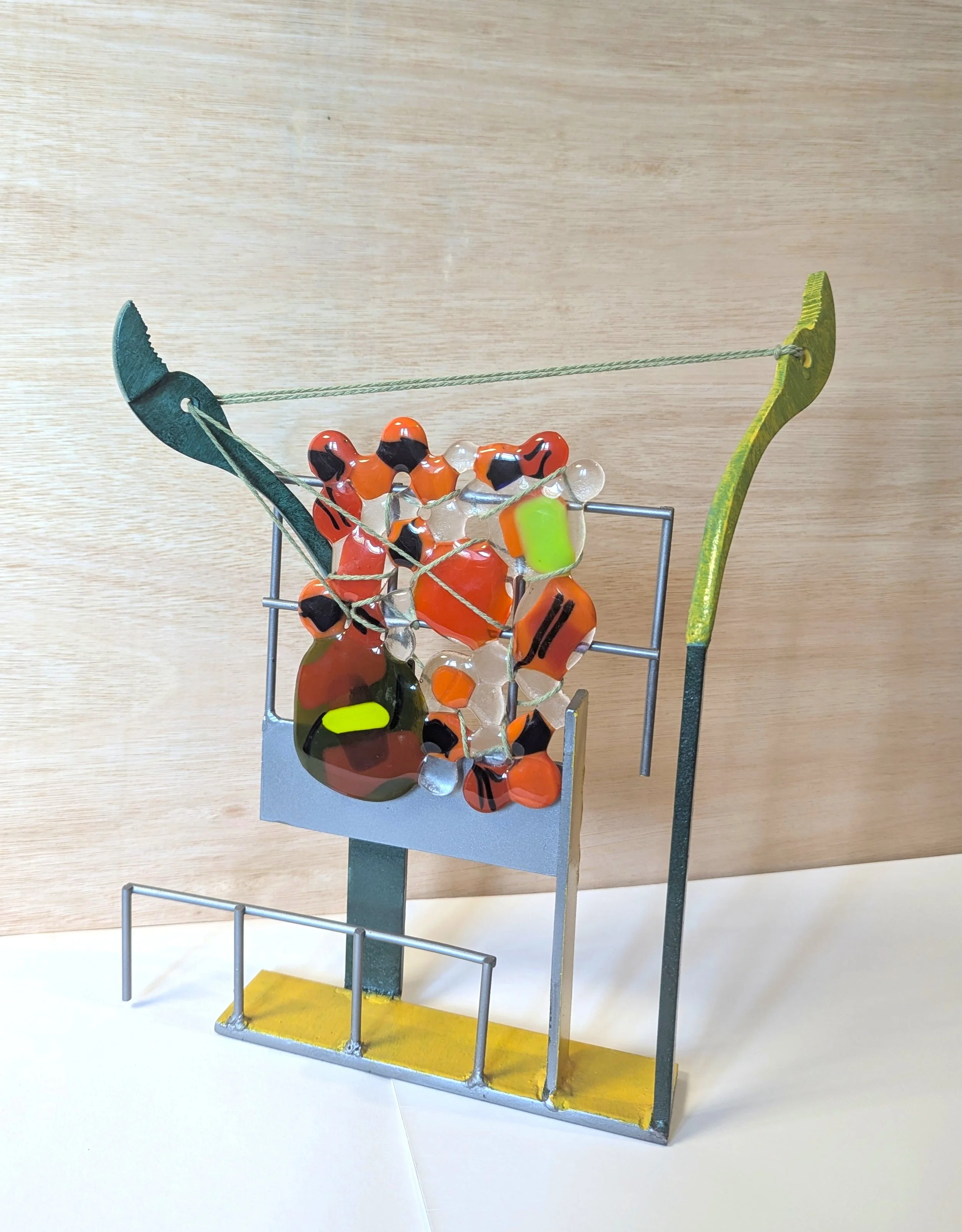 Tug, 2024, 37x25x9cm, reclaimed steel, fused glass & cotton yarn