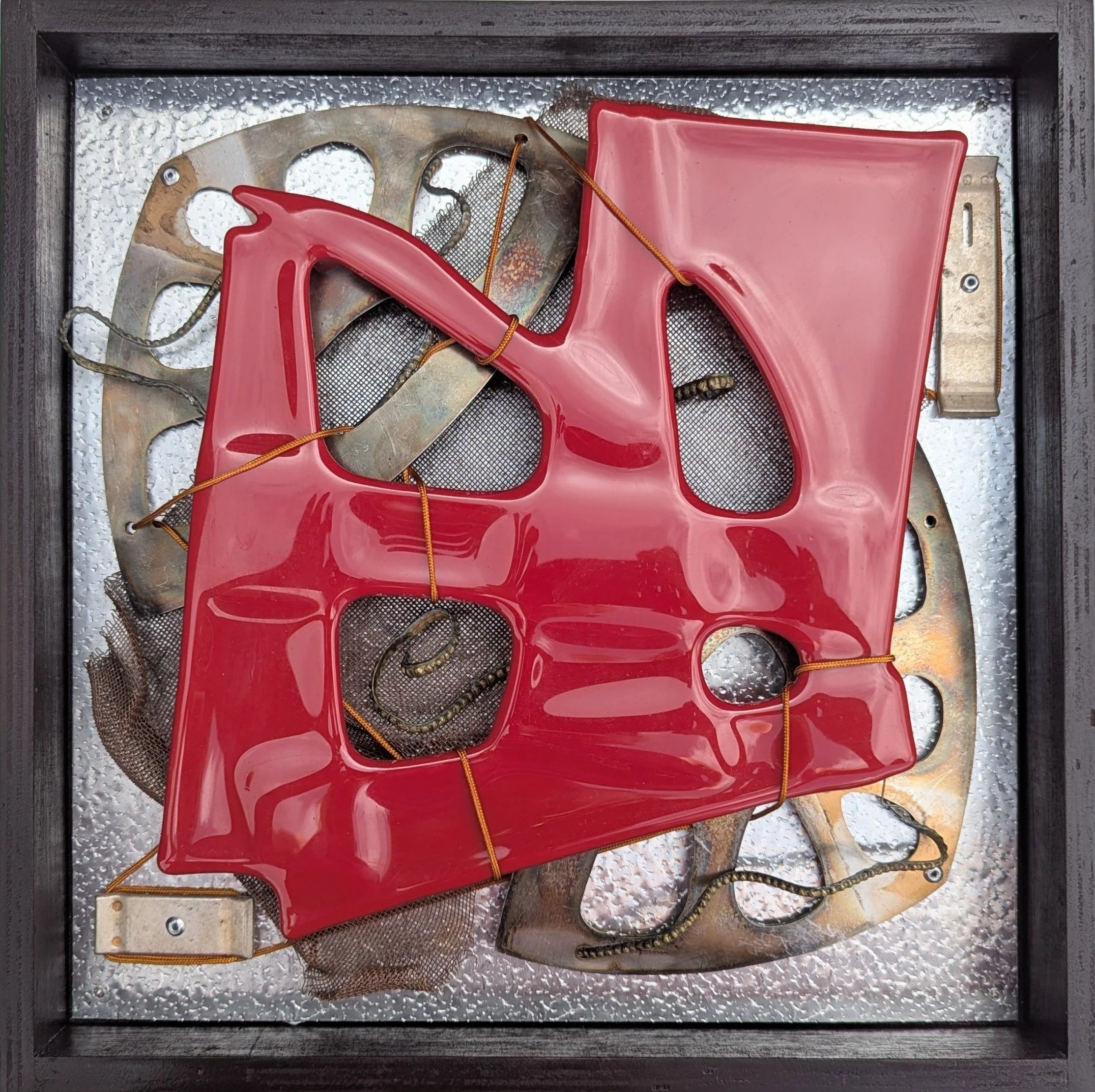 Behind Glass: Red,
33x33x4cm, 2026.
Fused glass, found metal & cord.