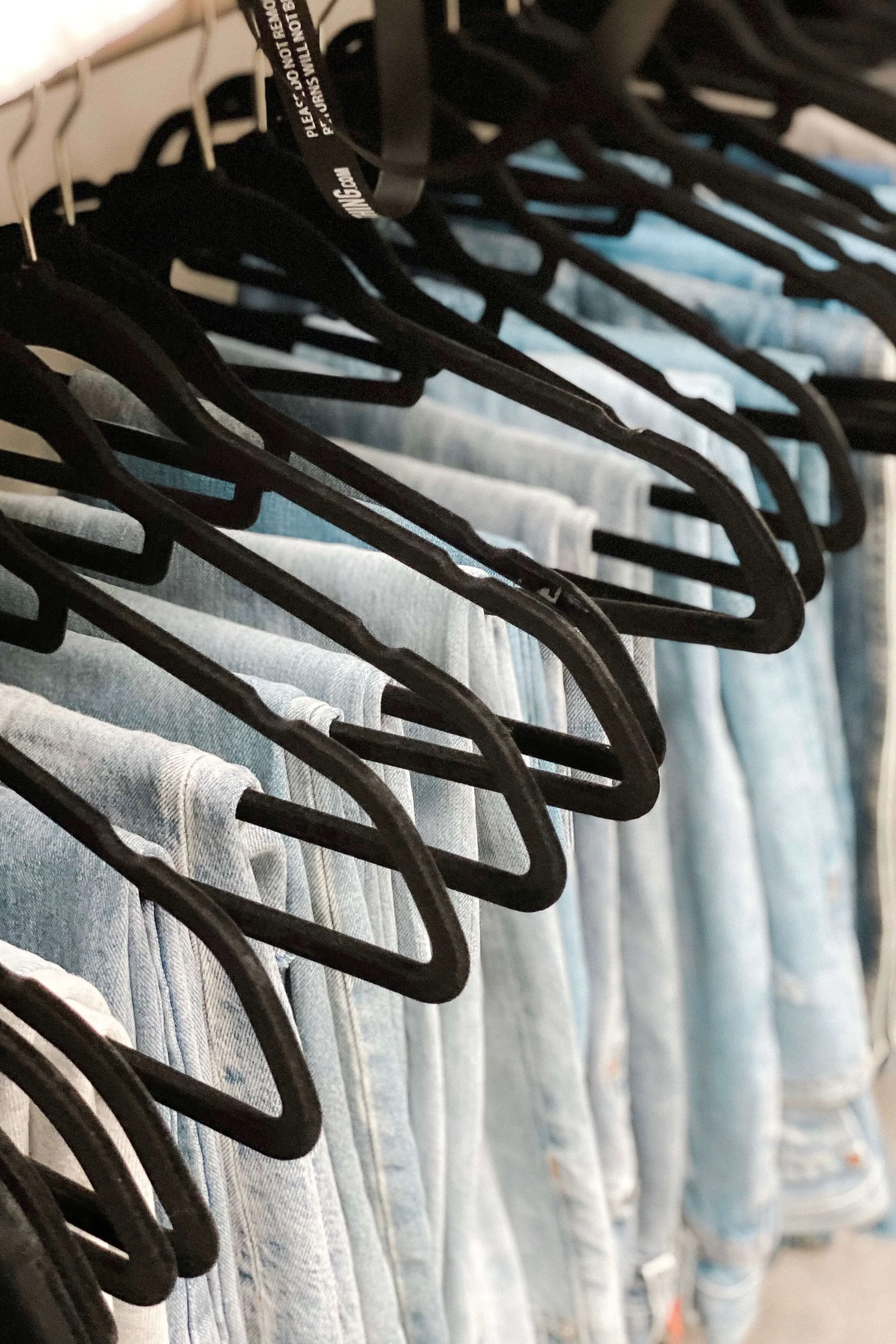 Clothes organized on black hangers