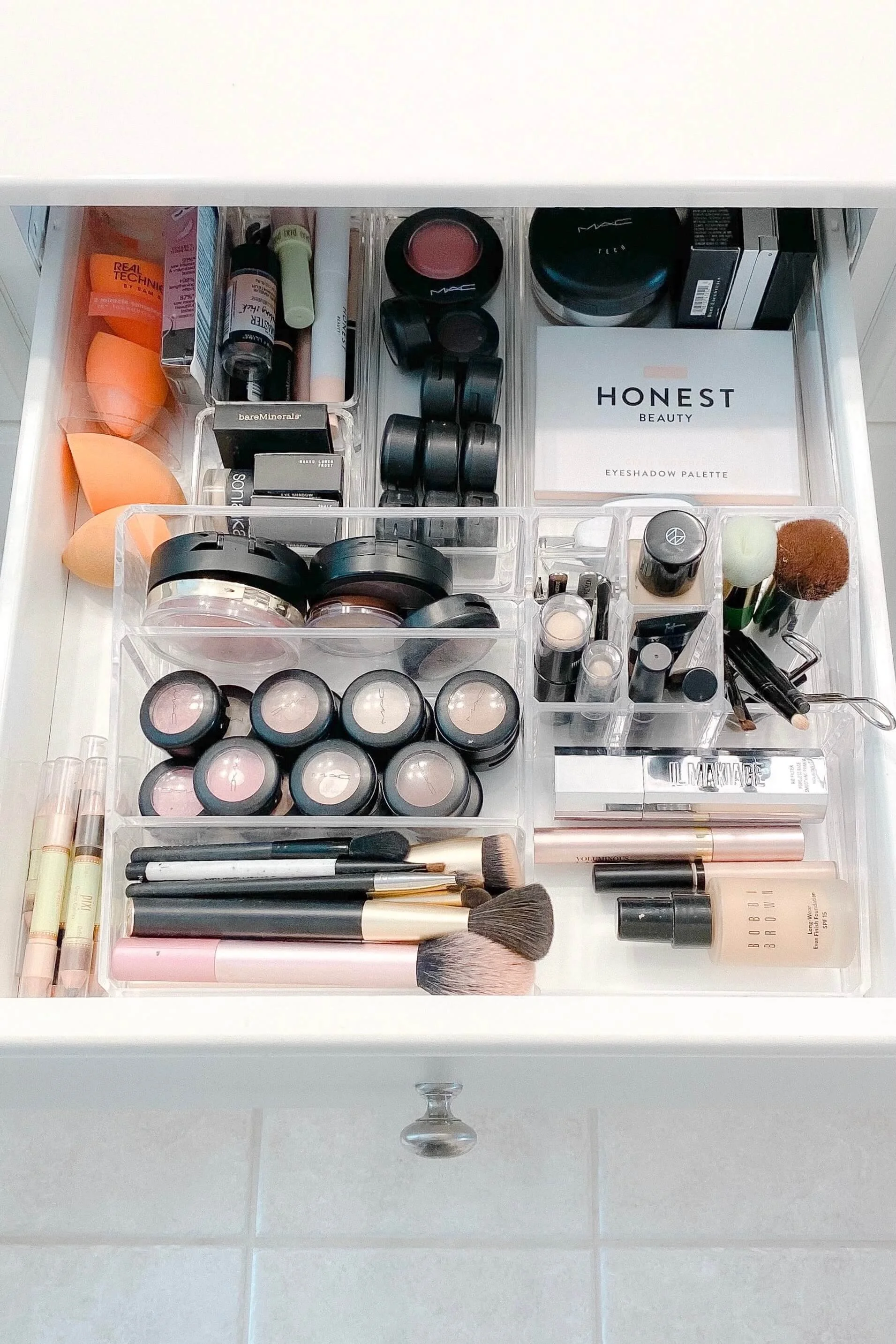 Makeup drawer that has been decluttered and organized with clear drawer dividers