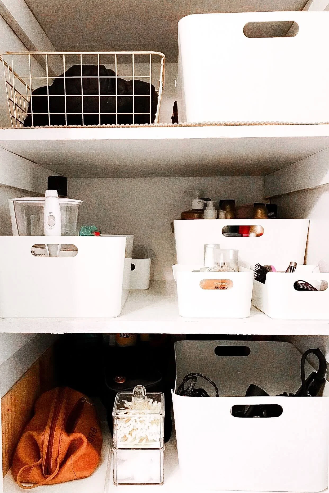 Simple white bins provide spaces for toiletries to stay organized and neat