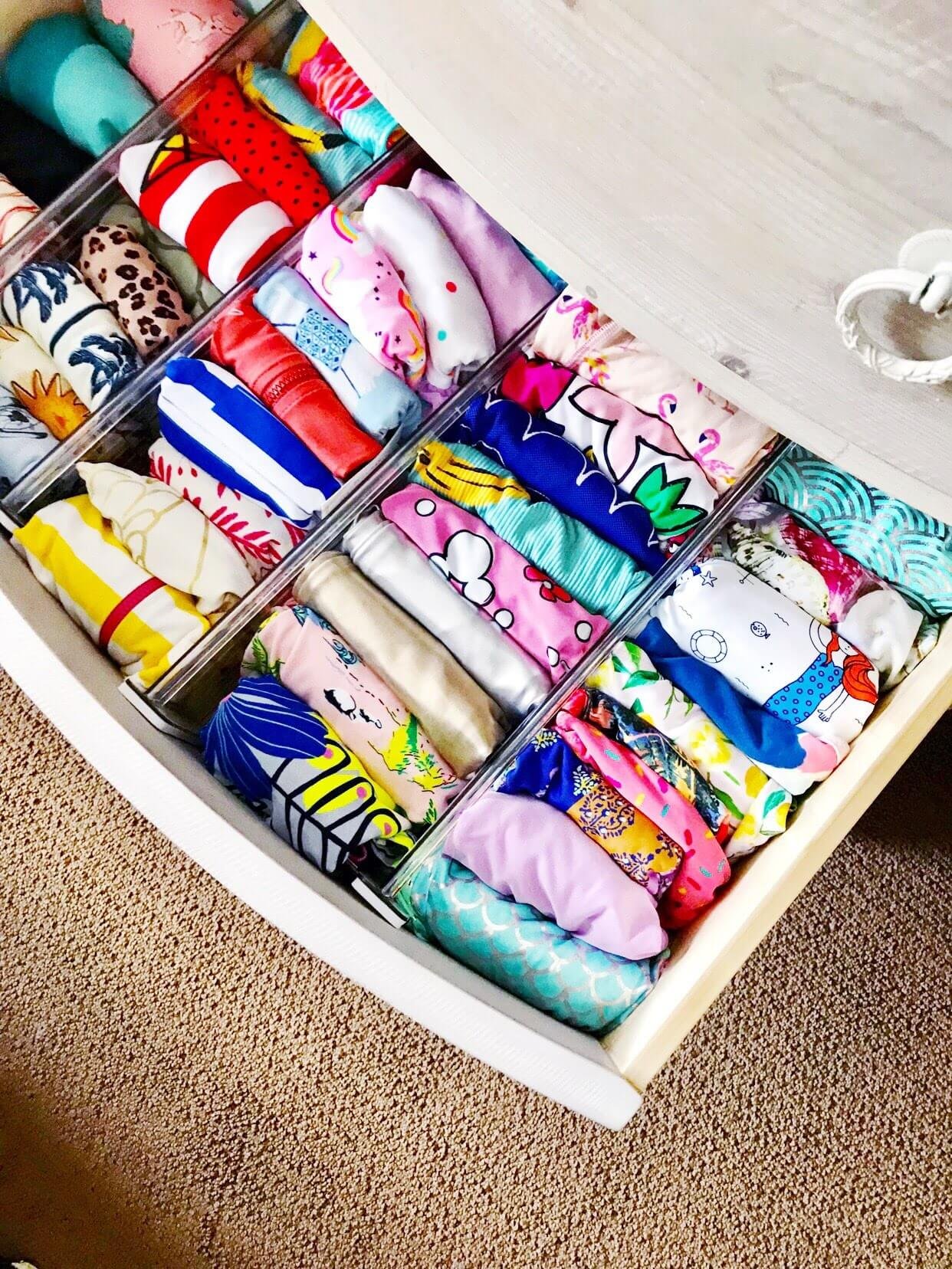 Kid's Clothes Neatly Folded In Dresser Drawer