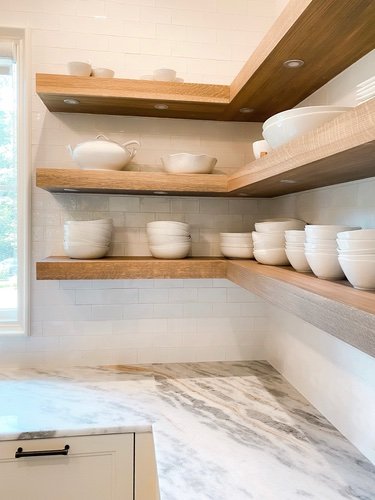 White dishes styled on open shelves