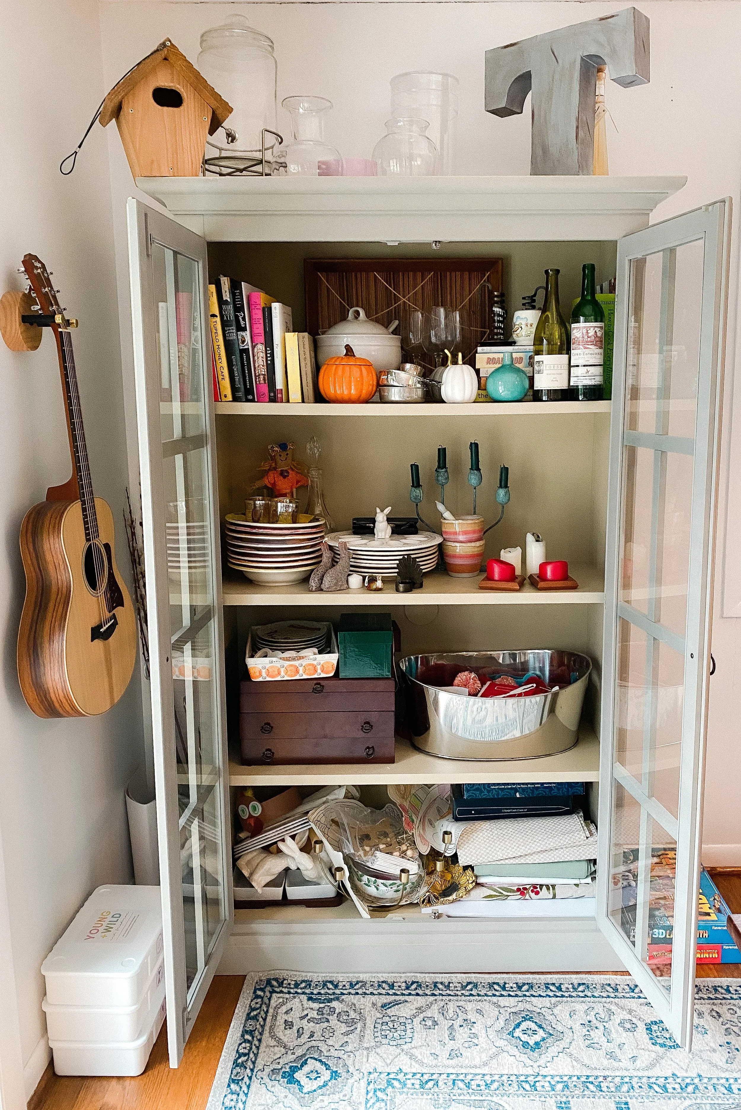 Before: Dining room cabinet cluttered and in need of organization