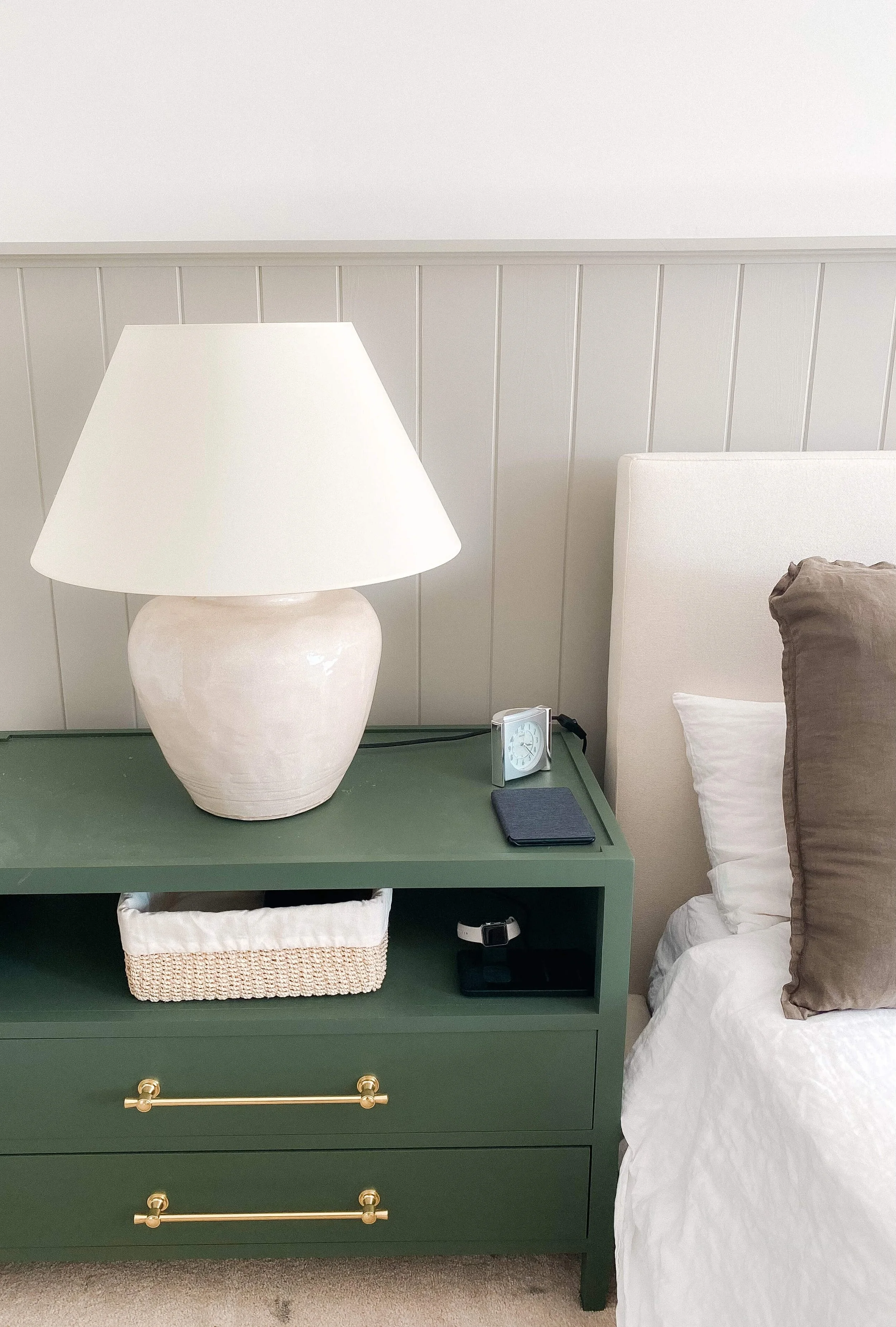 Nightstand with lamp and organized bedside storage