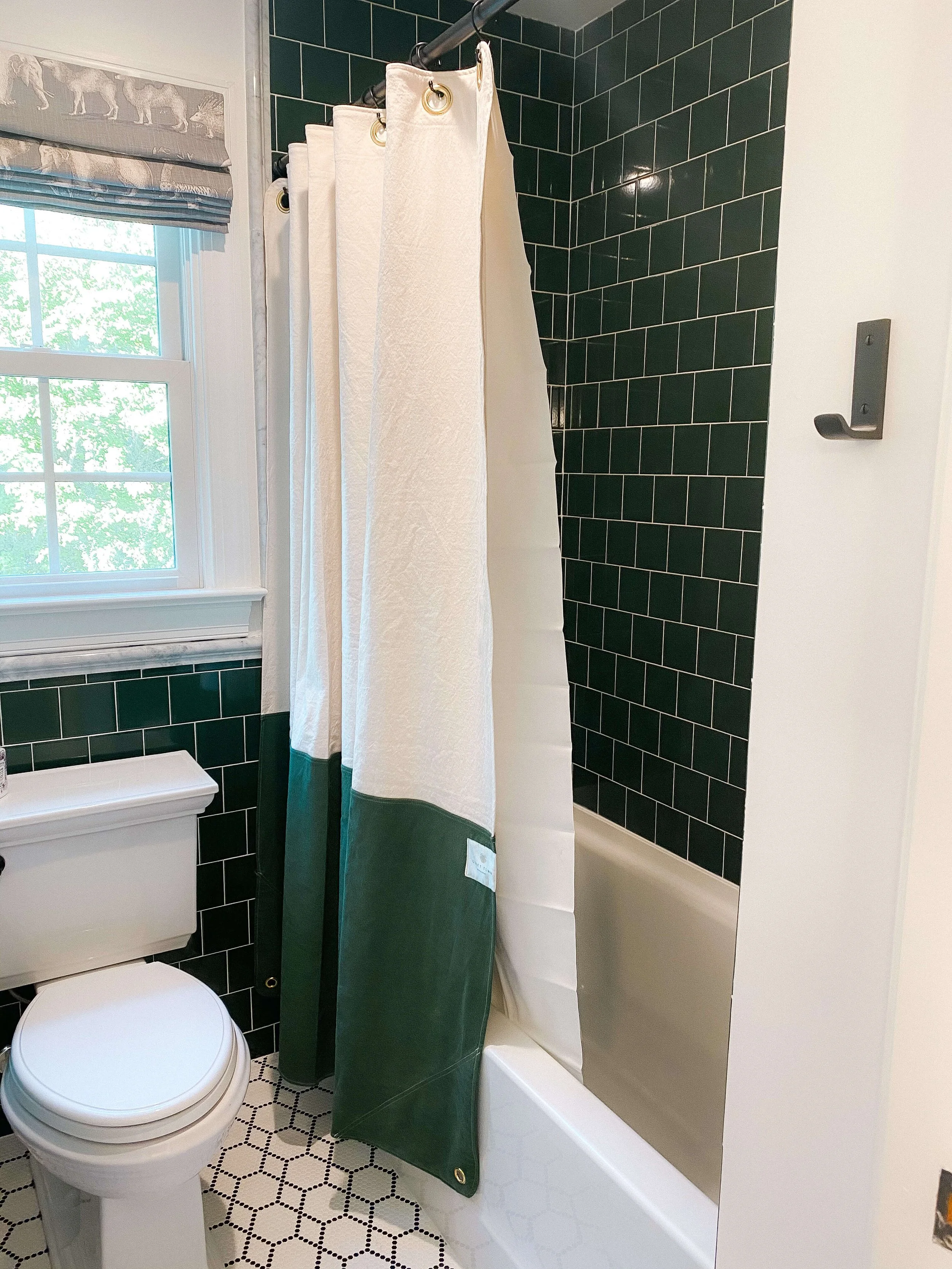 Guest bathroom with shower curtain and tiled shower