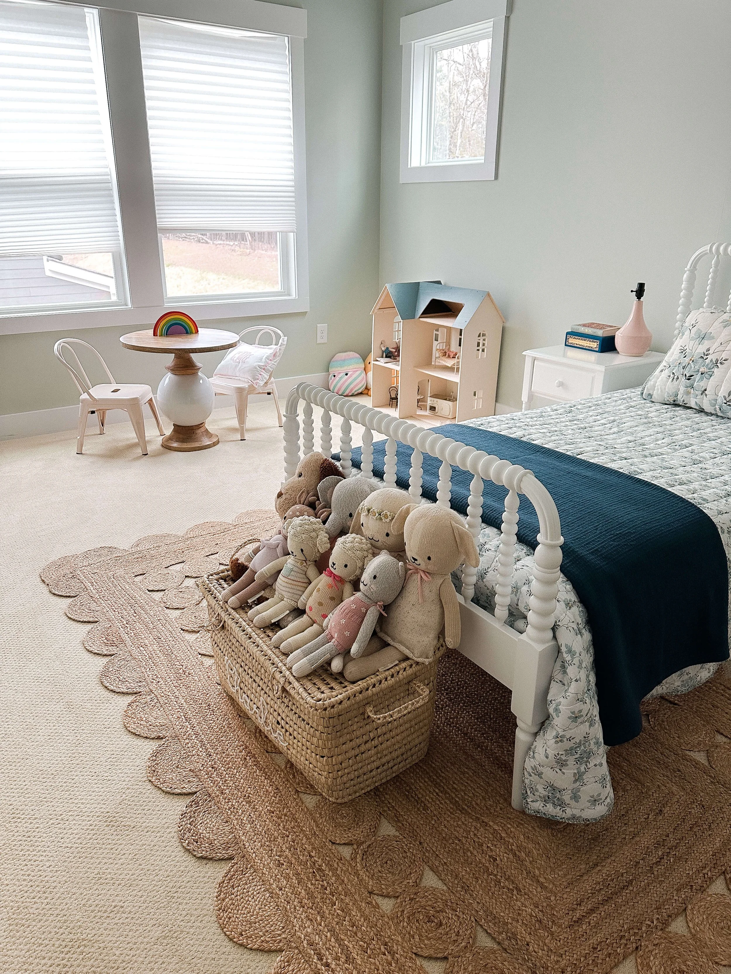 Organized children's bedroom with accessible toy storage, reading space, and clearly defined activity areas.