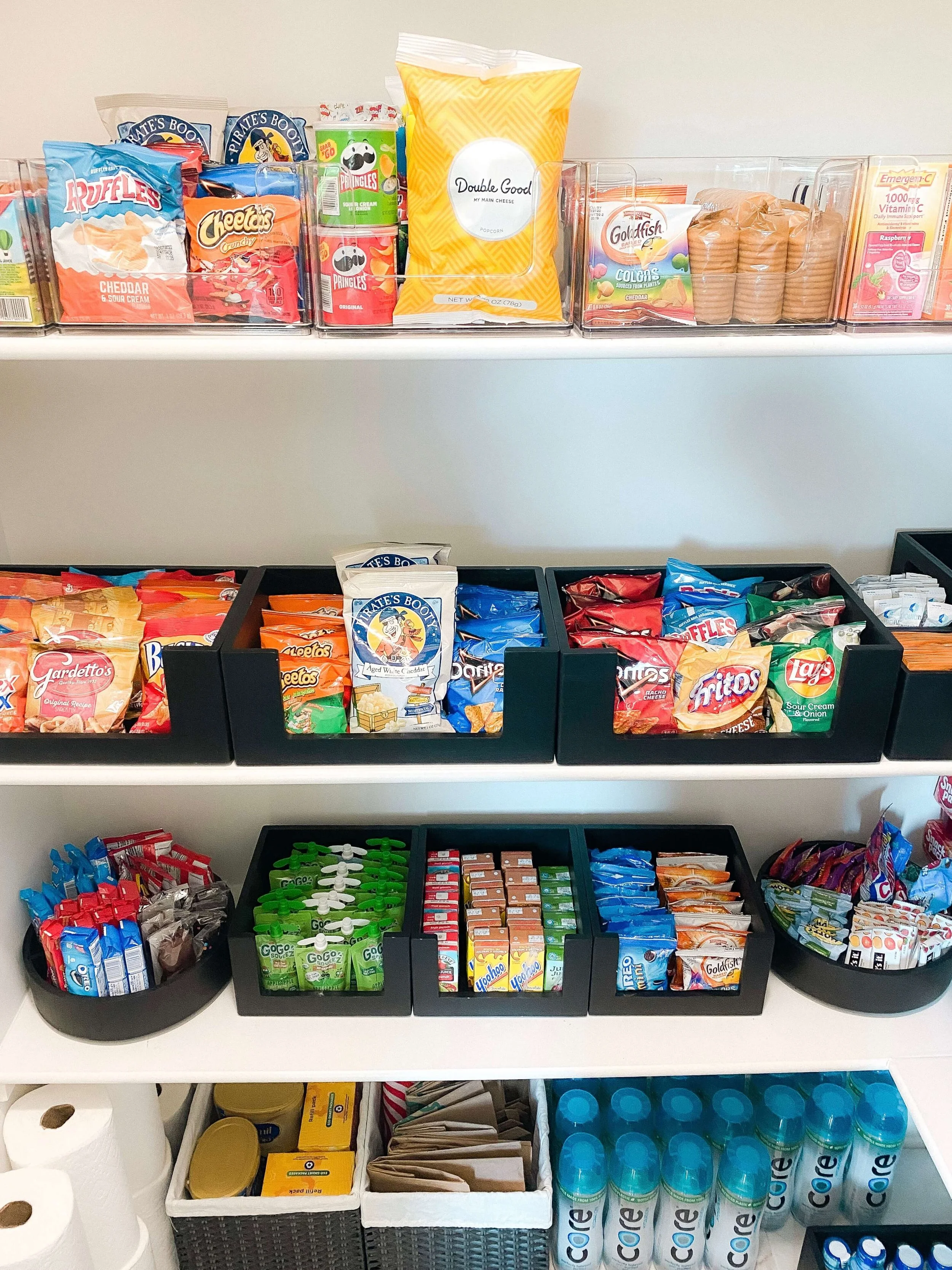 Pantry snack station with cereal dispensers, beverages, and grouped convenience foods.