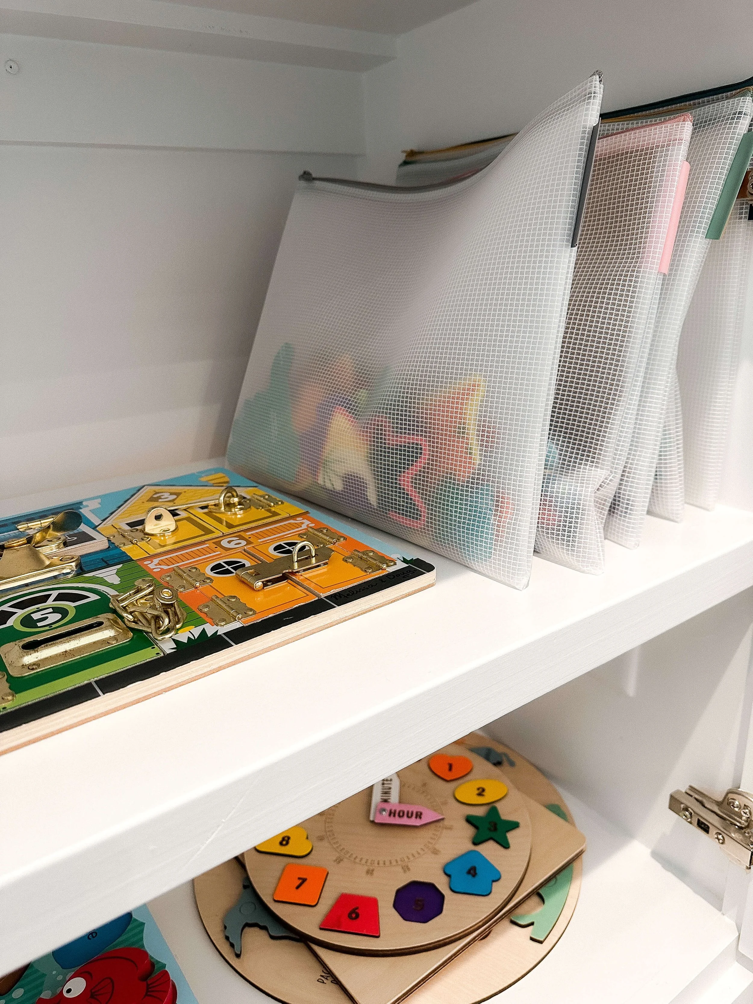 Puzzle boards and learning activities stored upright in zippered organizers