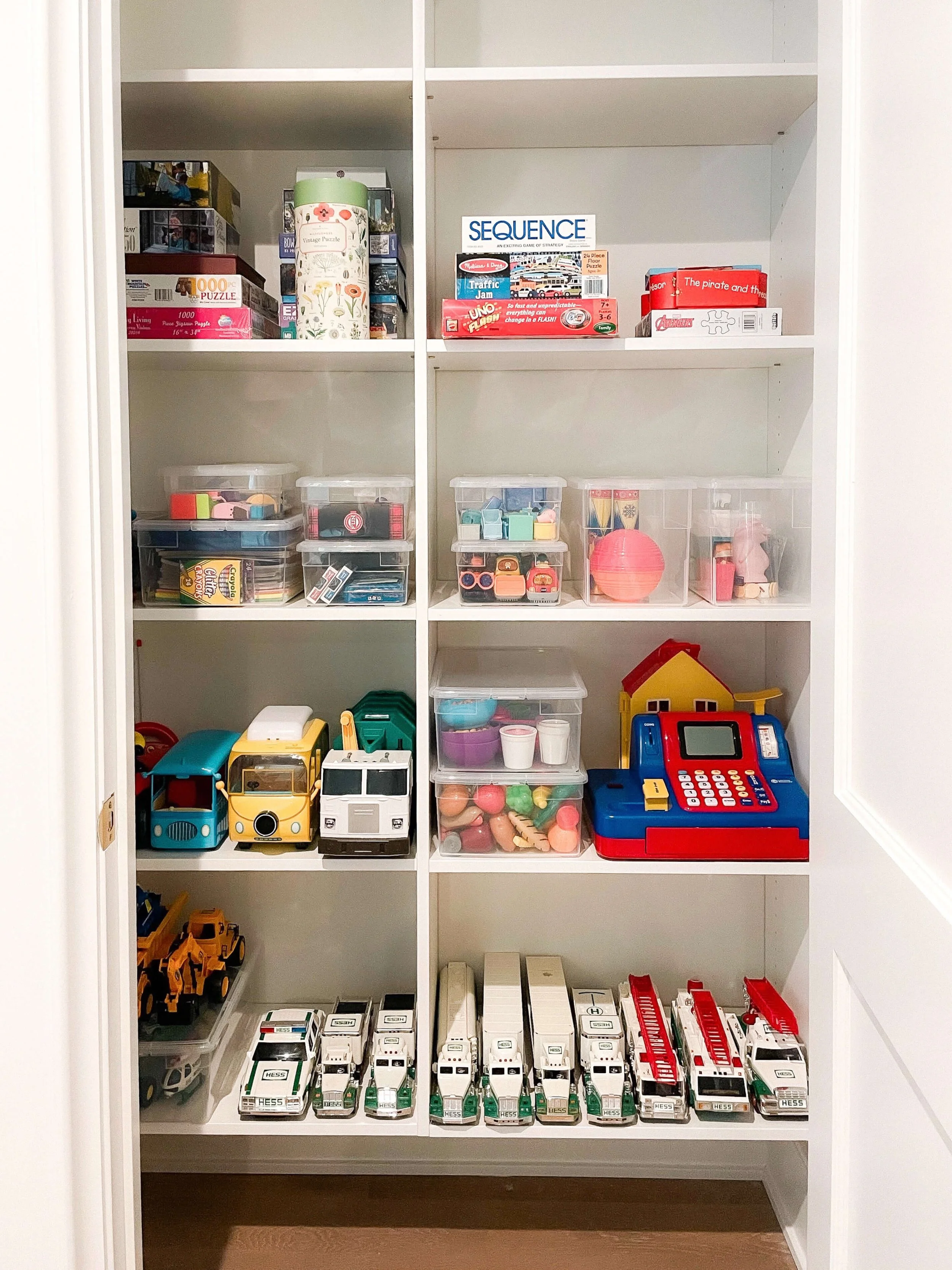 Built-in toy closet with games, puzzles, vehicles, and activity bins