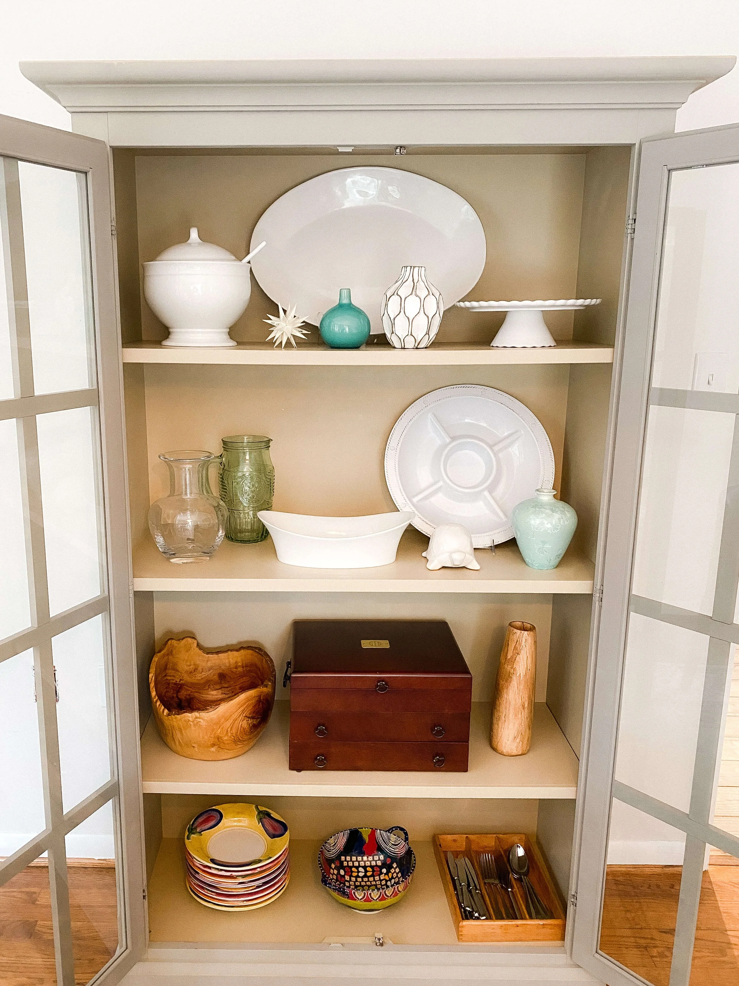  Organized Charlotte china cabinet with platters, cake stands, and serving pieces arranged for entertaining. 