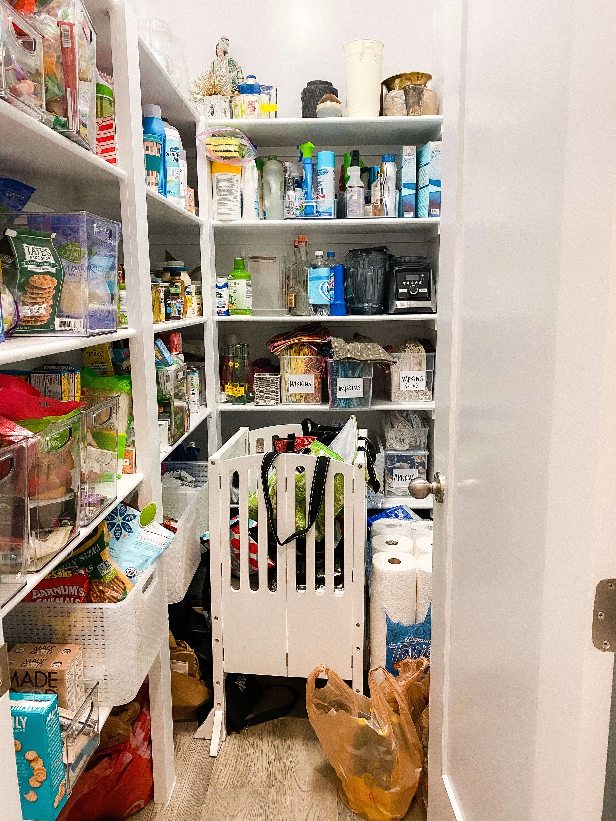  Cluttered Raleigh pantry before organizing, with overcrowded shelves and grocery bags on the floor 