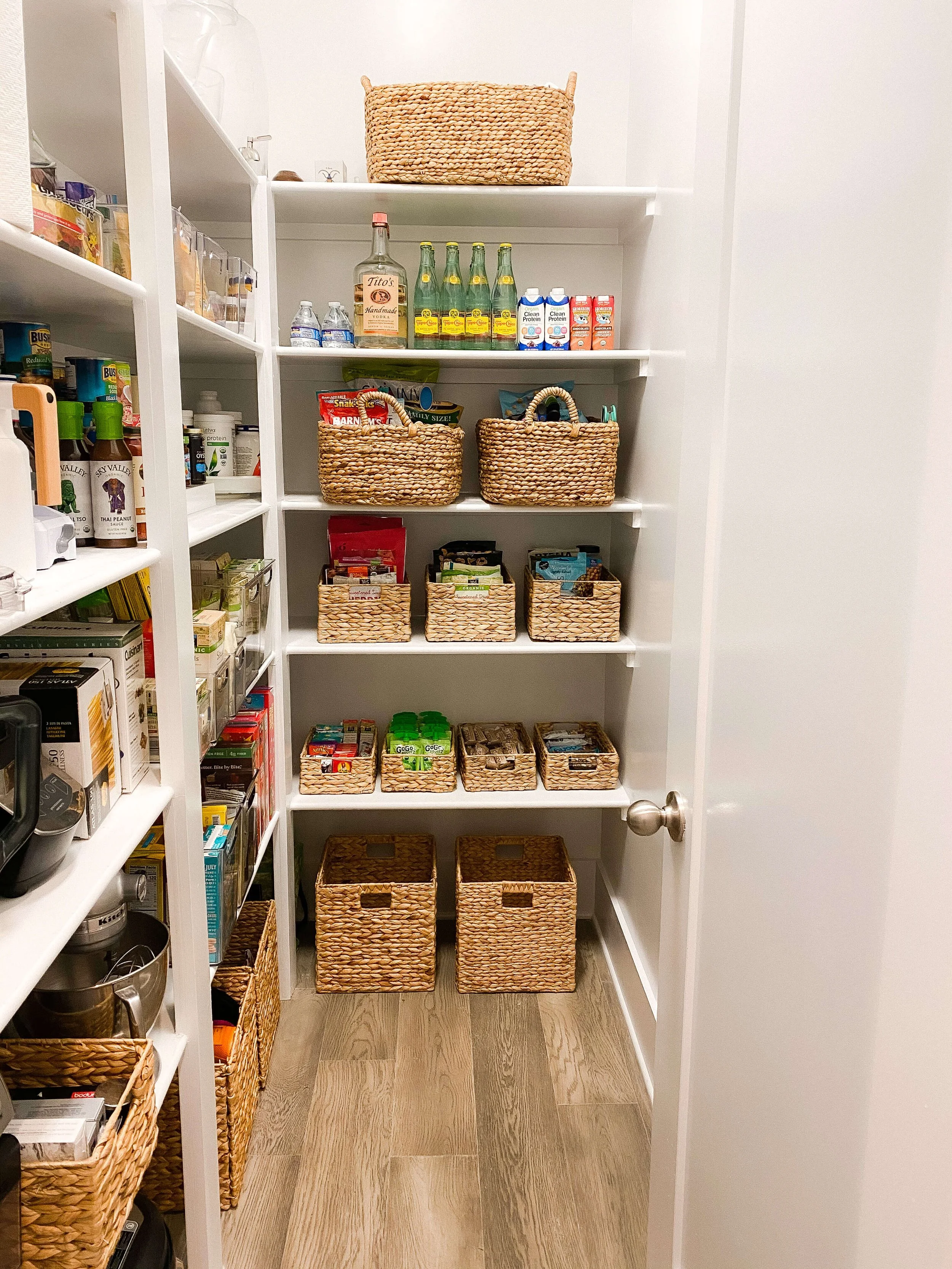  Organized Raleigh pantry with woven baskets and labeled zones after a professional organizing project 