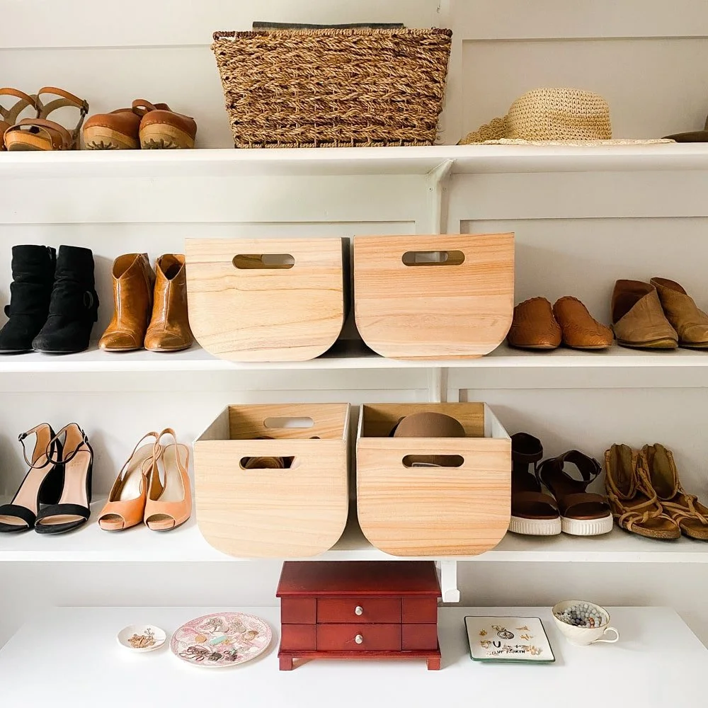 Wooden bins and baskets with shoes in an organized closet