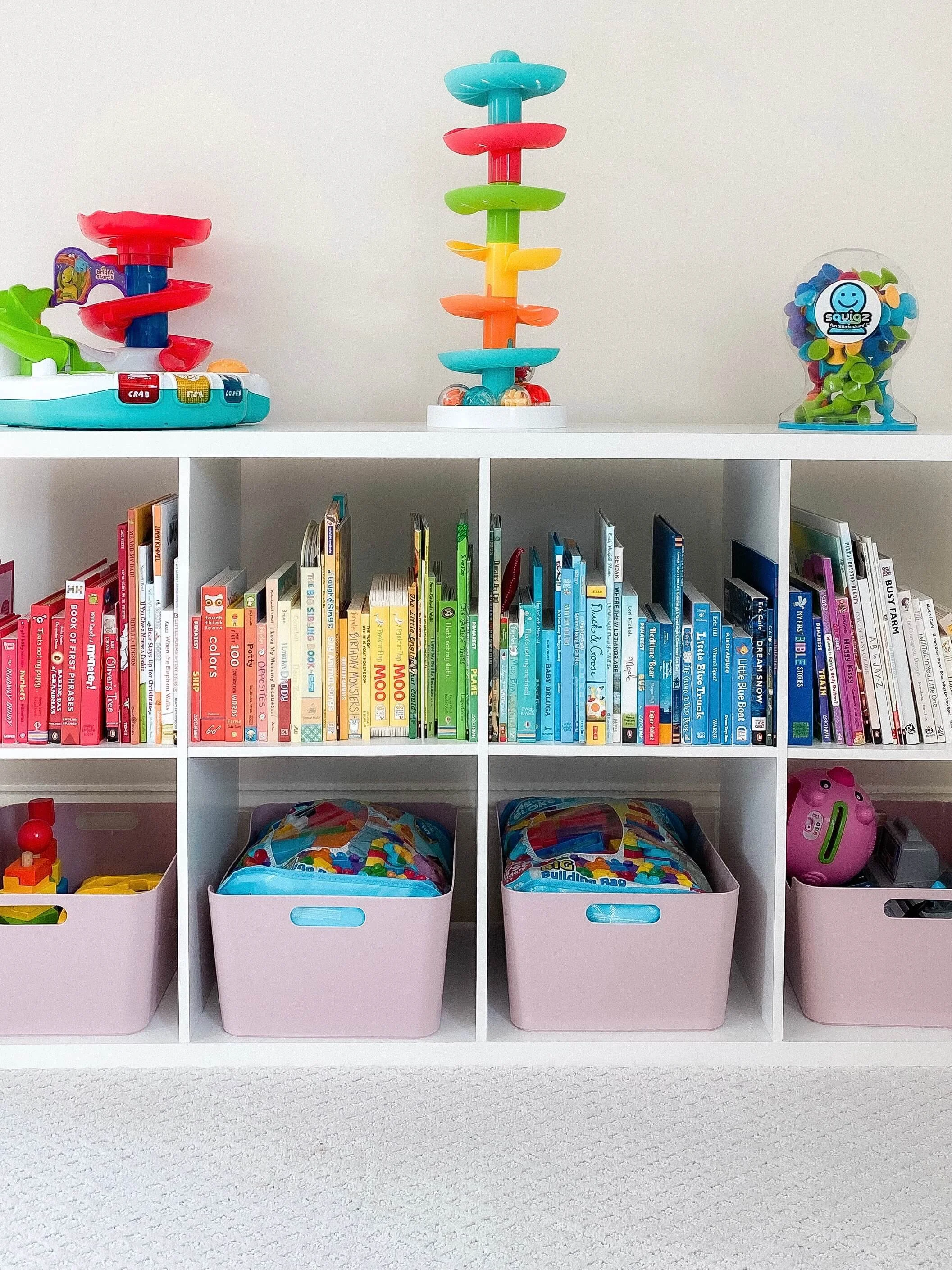 Books and children's toys organized on cubby shelves