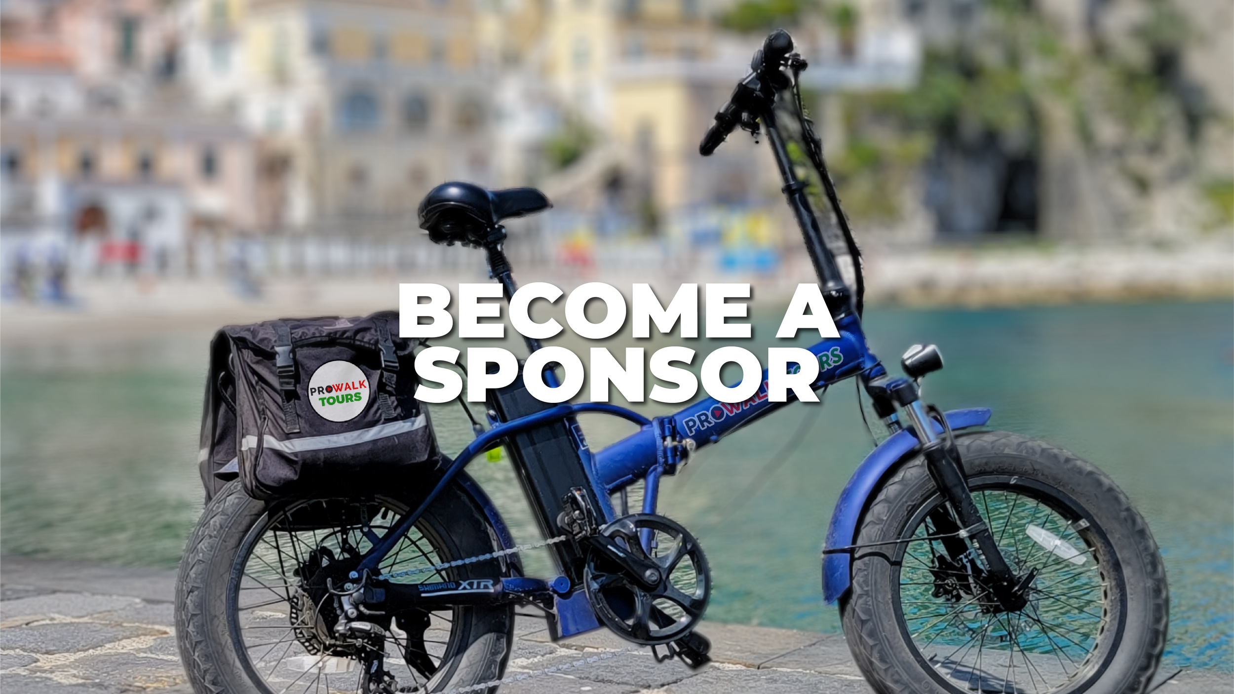 Blue electric bicycle with a black saddlebag on a stone pathway beside a body of water, with colorful buildings in the background, and white text overlay saying 'Become a Sponsor'.
