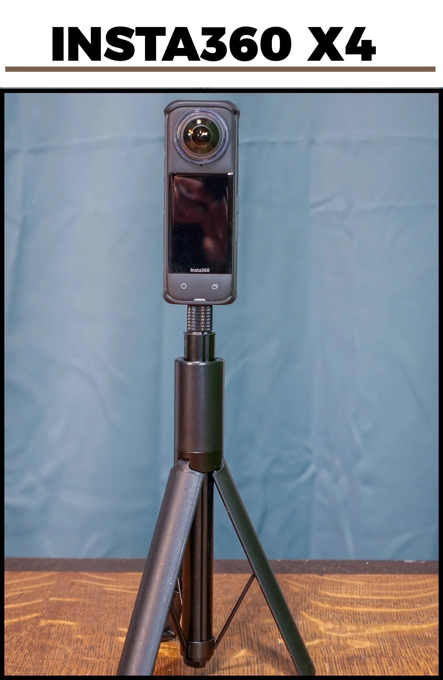 A camera mounted on a tripod with a blue background and a sign above reading 'INSTA360 X4'.