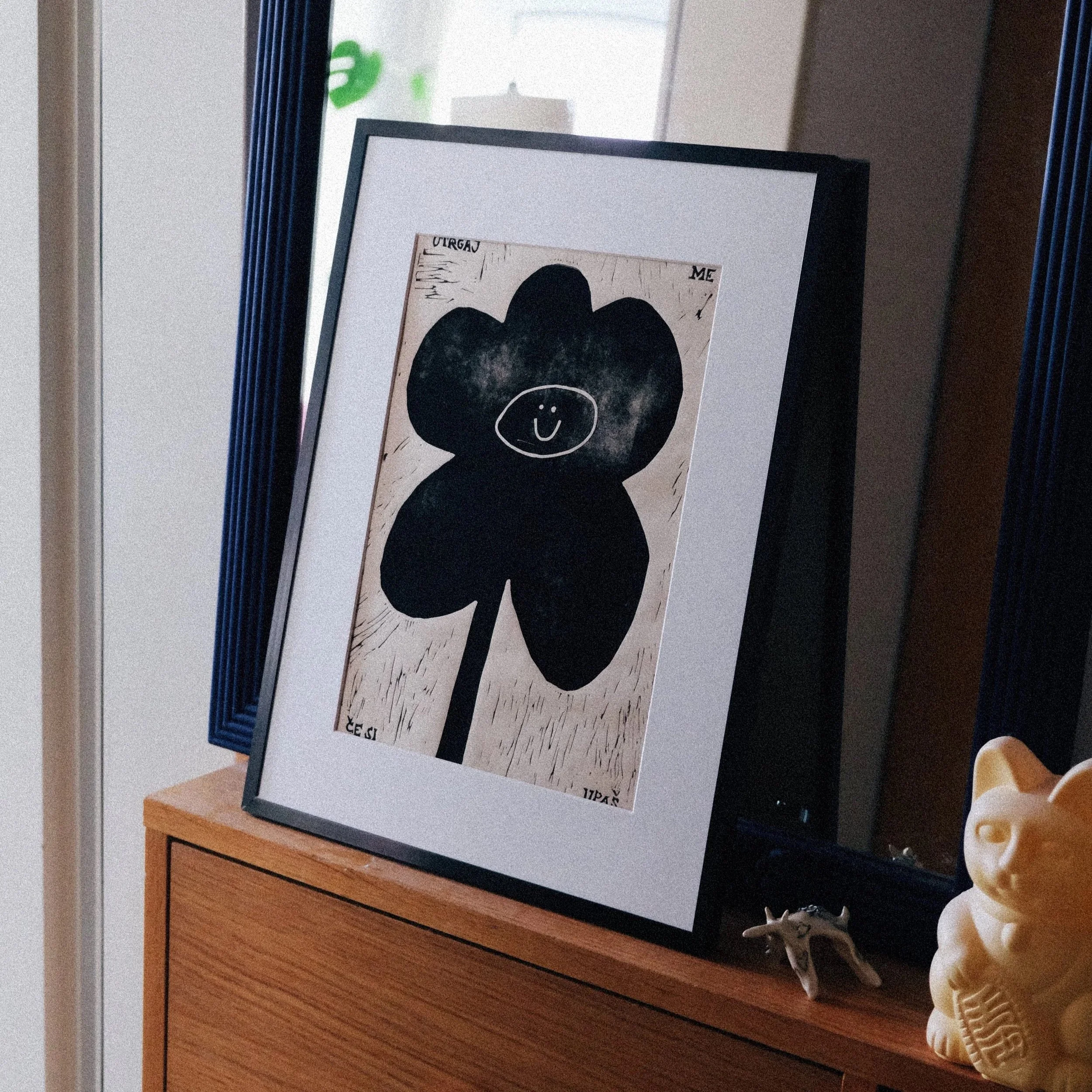 Minimalist black flower print with a smiley face, modern playful floral wall art poster_MALA-MAJA