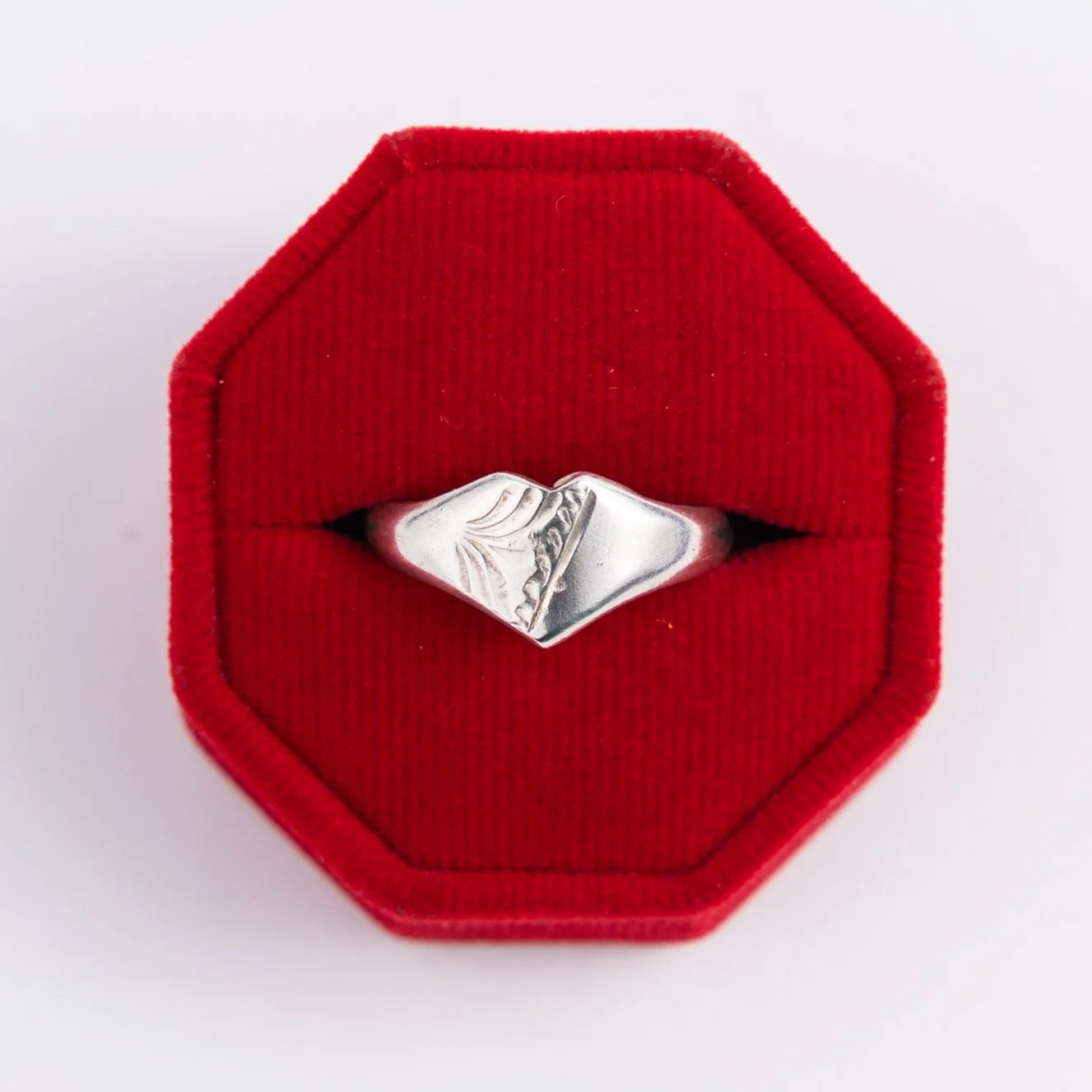 Single vintage silver ring displayed in a red velvet jewelry box, part of Sorrell Jewels’ curated vintage collection.
