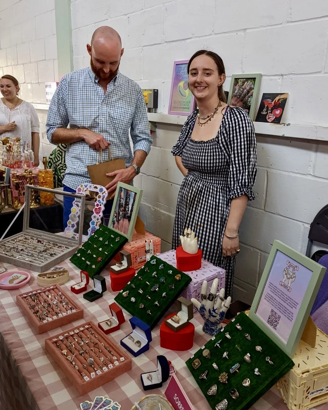 Emily Sorrell at an in-store Sorrell Jewels pop-up, standing behind a display promoting her vintage jewellery collections.