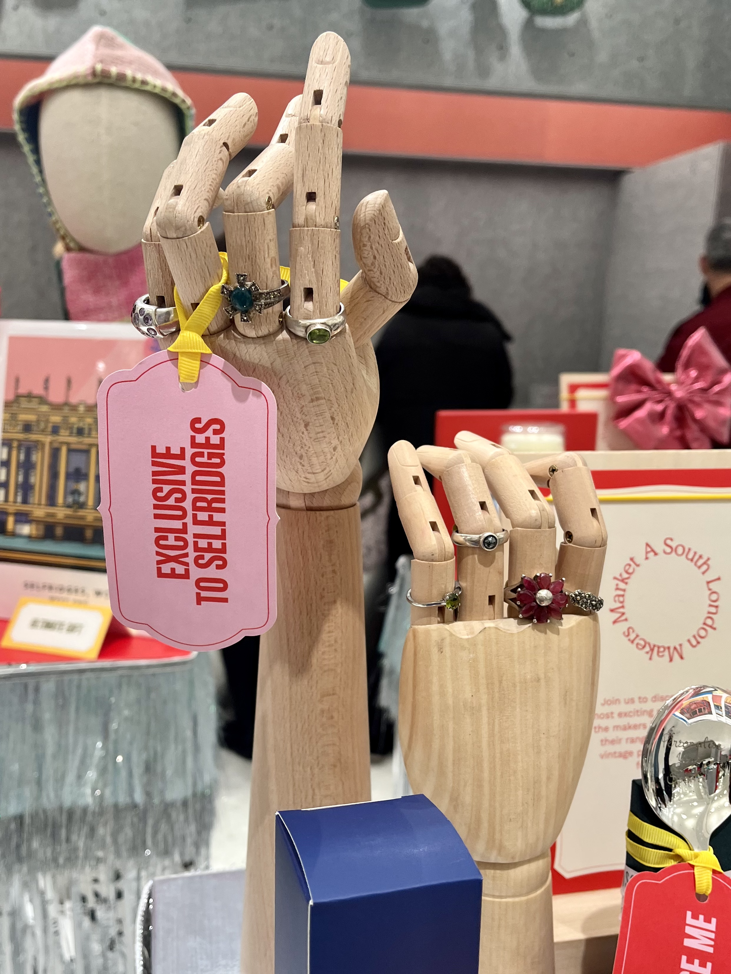 Sorrell Jewels exclusive ring collection displayed on wooden mannequin hands at a Selfridges pop-up event.