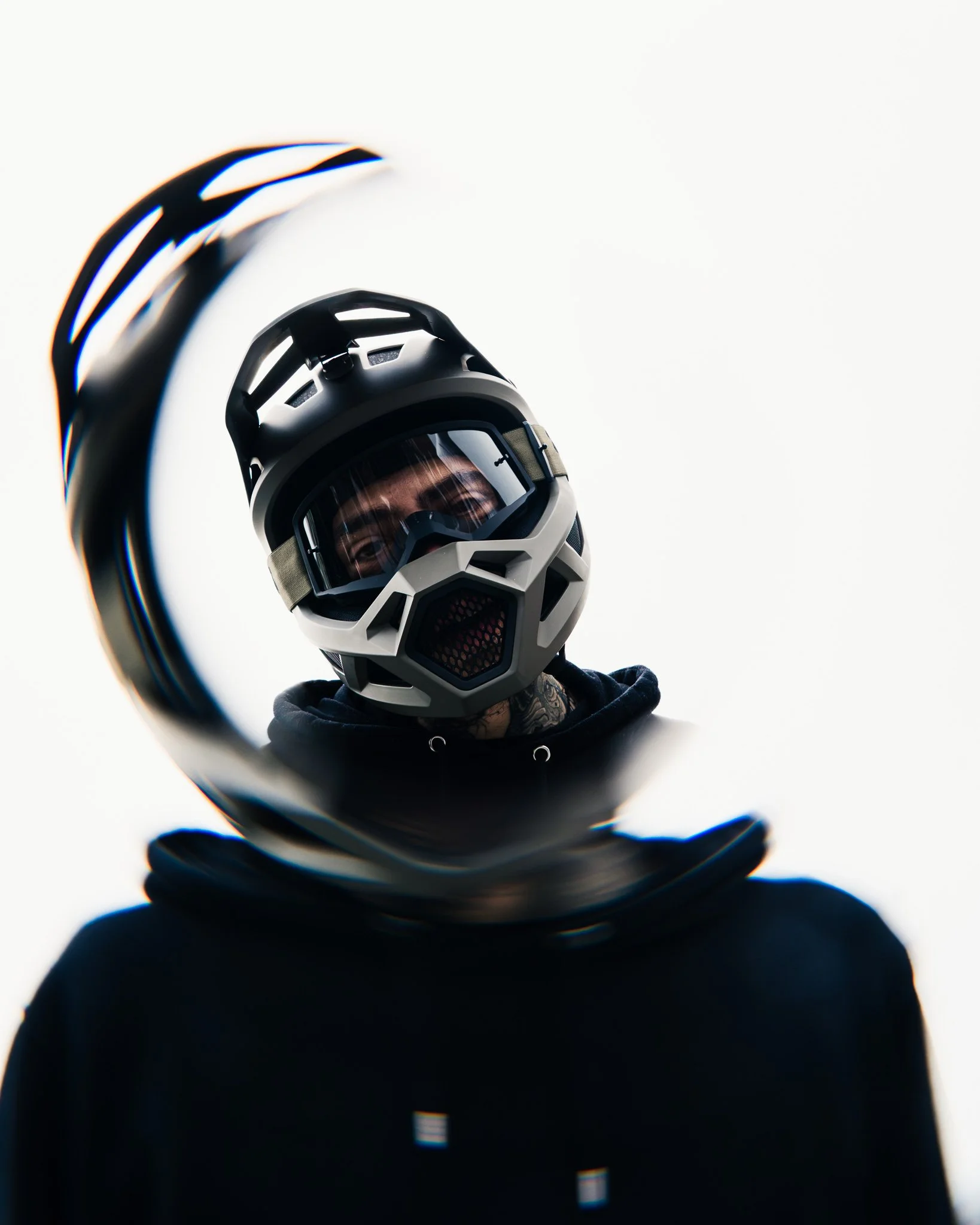 Person wearing a full-face mountain biking helmet with goggles, showing reflection in the goggles.