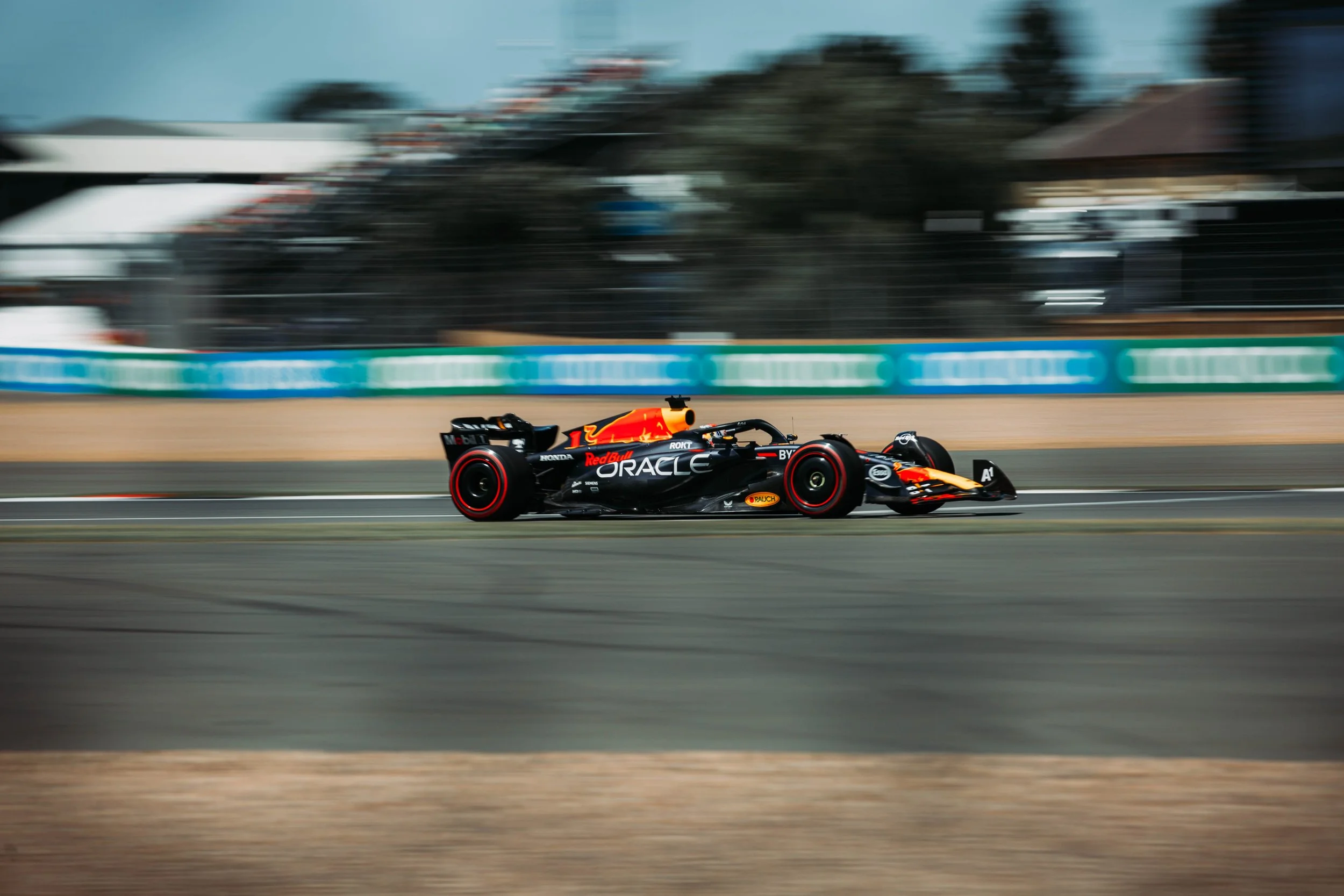A Formula 1 race car driving at high speed on a race track.
