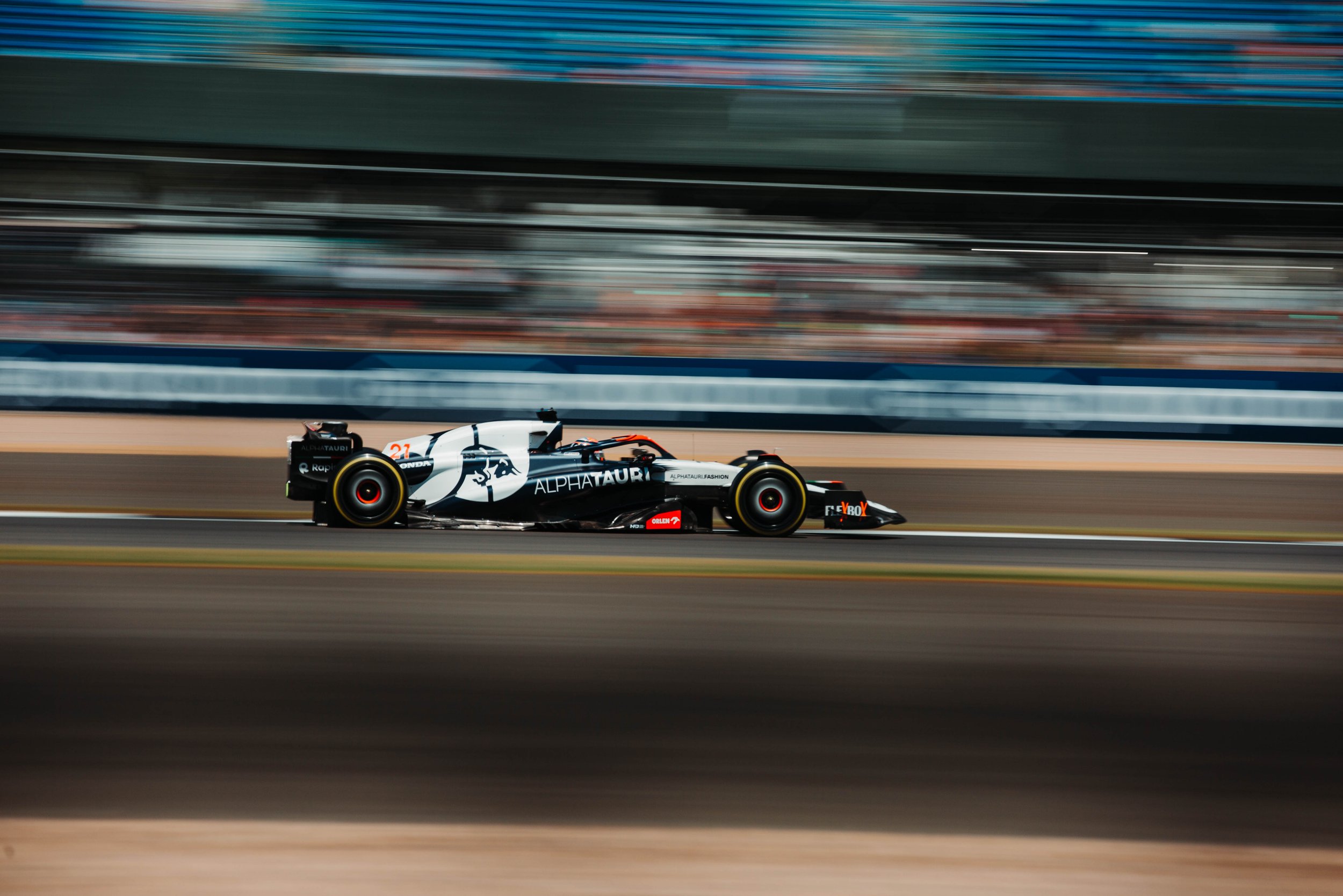 Race car speeding on a racetrack with motion blur background.