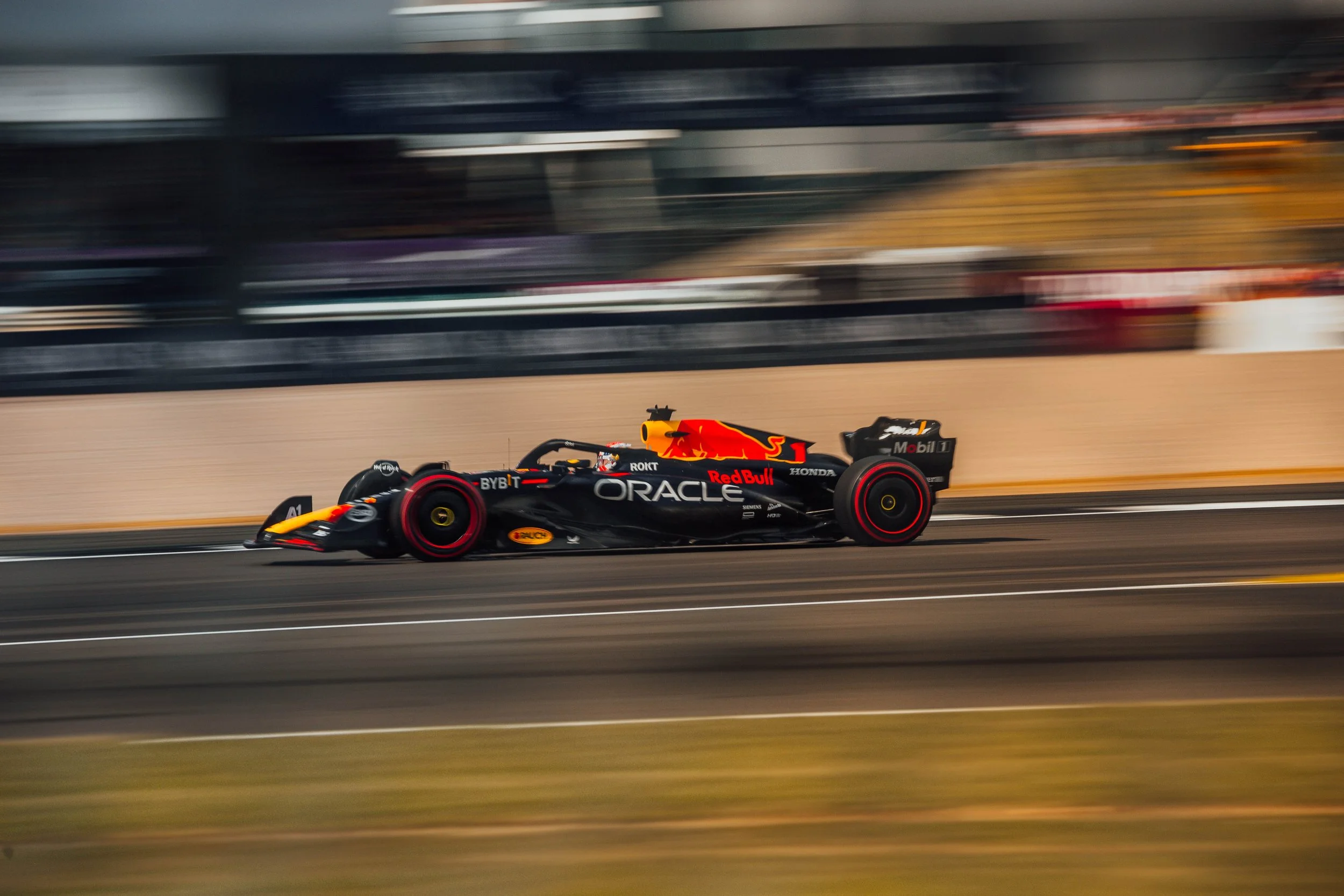 A Red Bull Racing Formula 1 car in motion on a race track with blurred background