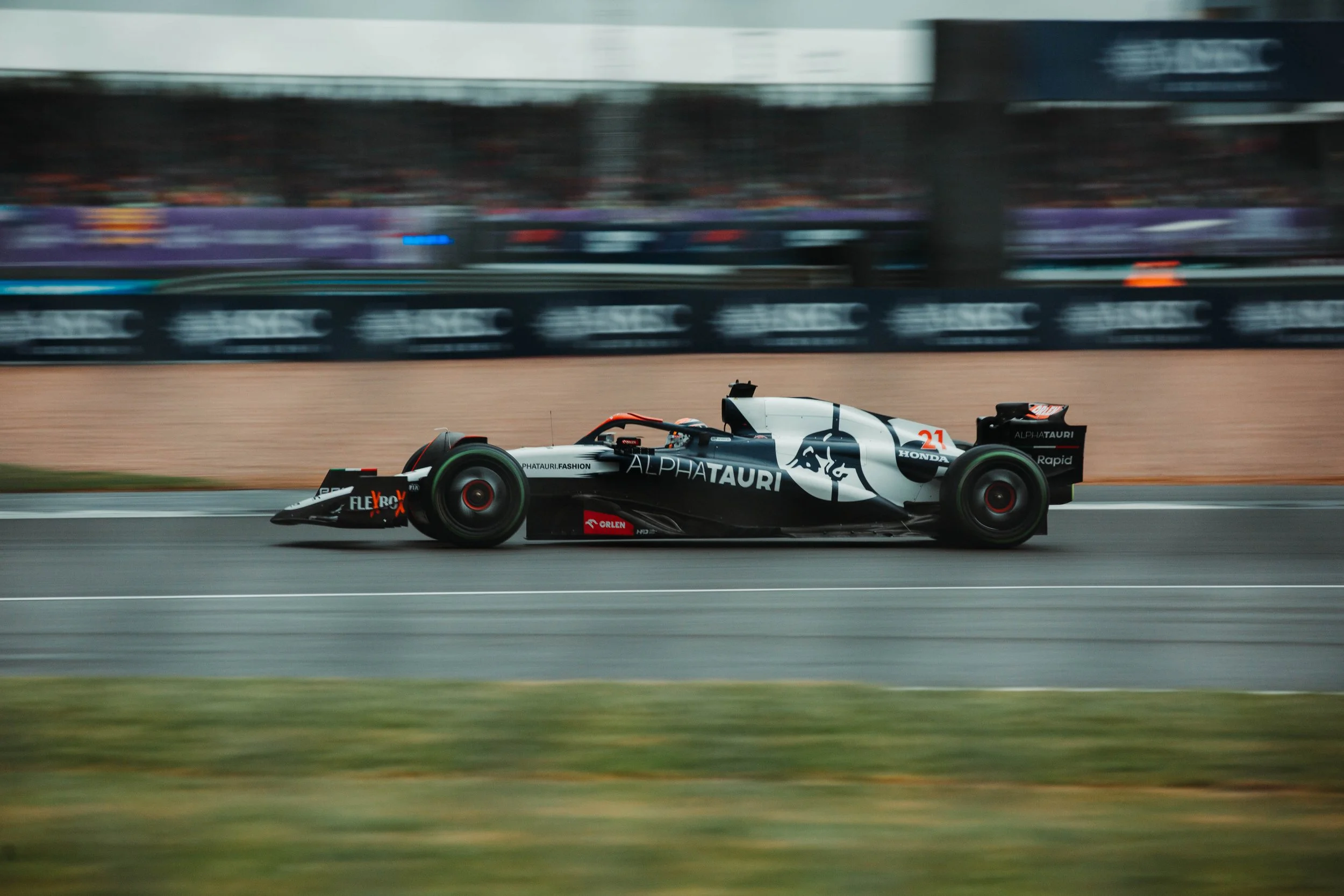 A Formula 1 race car speeding on a racetrack during a competition.