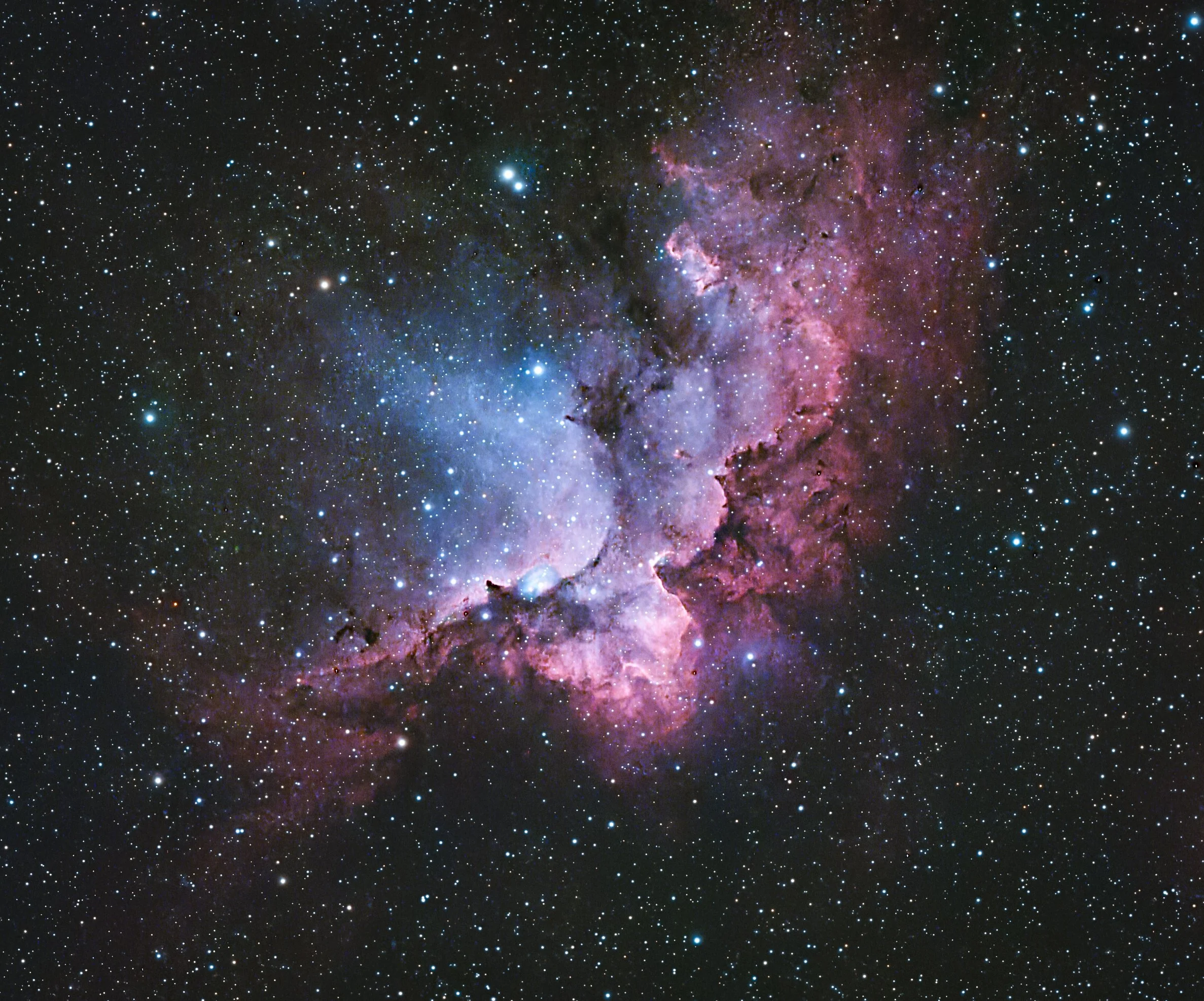 The Wizard nebula, an emission nebula in the constellation Cepheus, approximately 7,200 to 8,500 light years away.  A young, open star cluster is embedded in the nebula.  