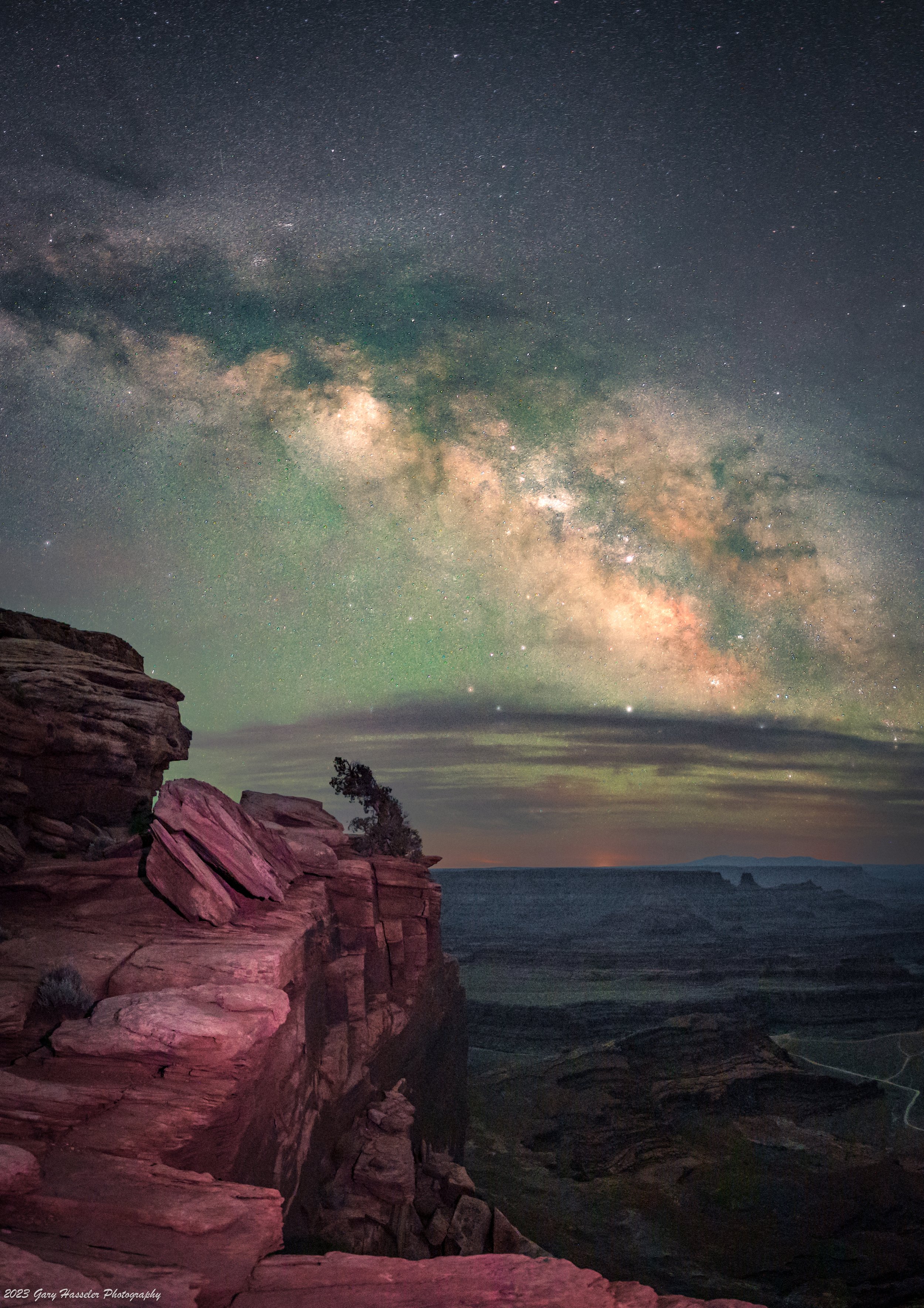 The Milky Way galactic core rising over the cliffs at Deadhorse Point state park in Utah. May.