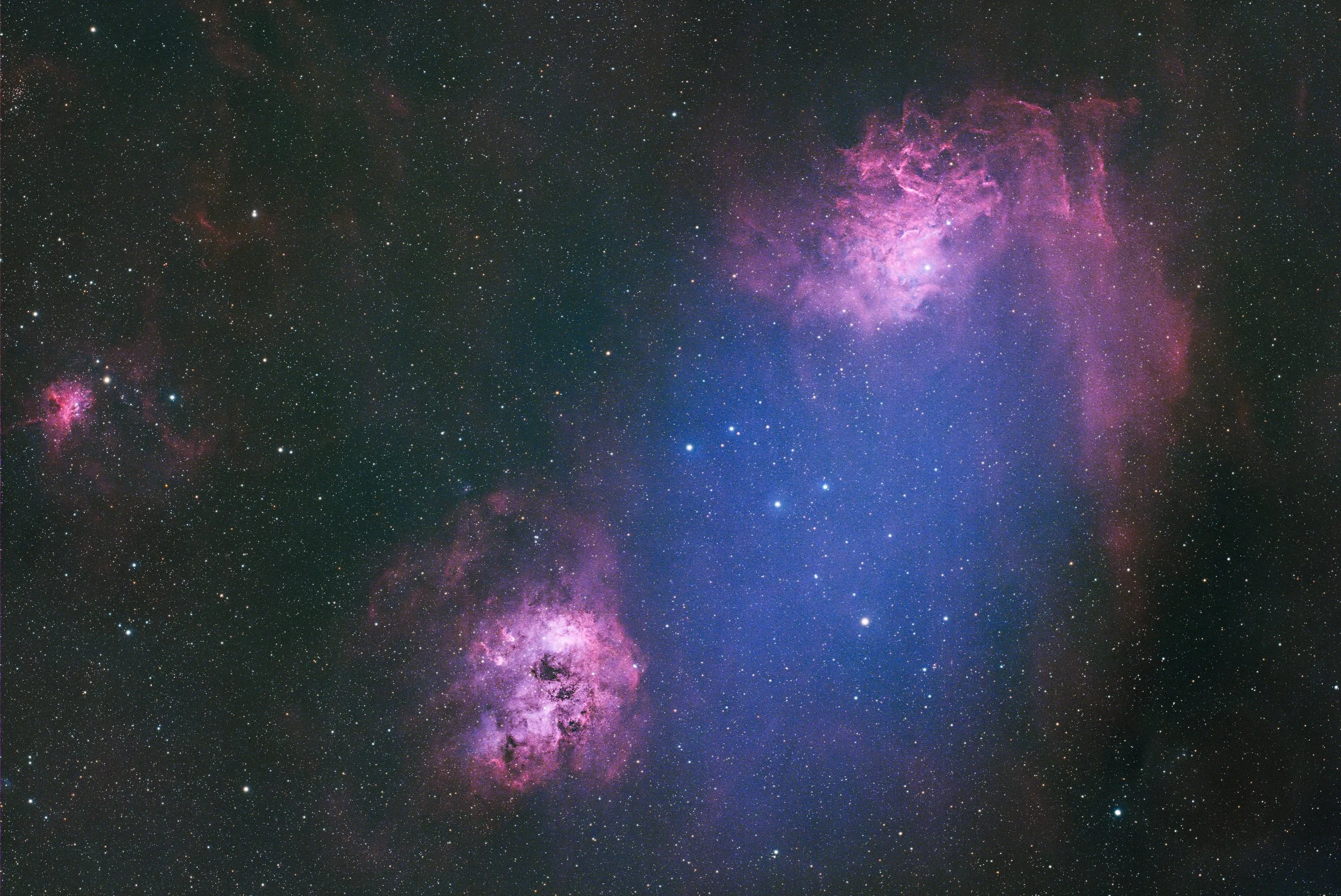 The Tadpoles (bottom) and Flame (upper right) nebulae. The Aurigae open star cluster is visible between the nebulae.