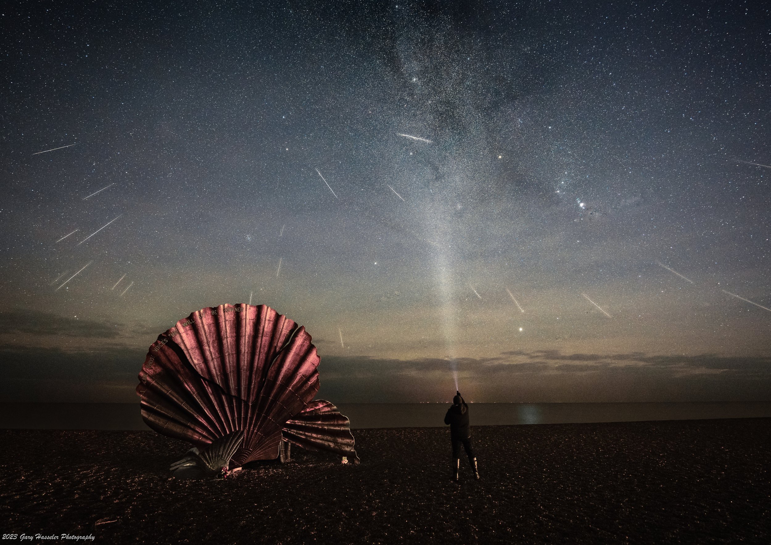 A composite image of Geminid meteors over the scallop sculpture on Aldeburgh beach. December.