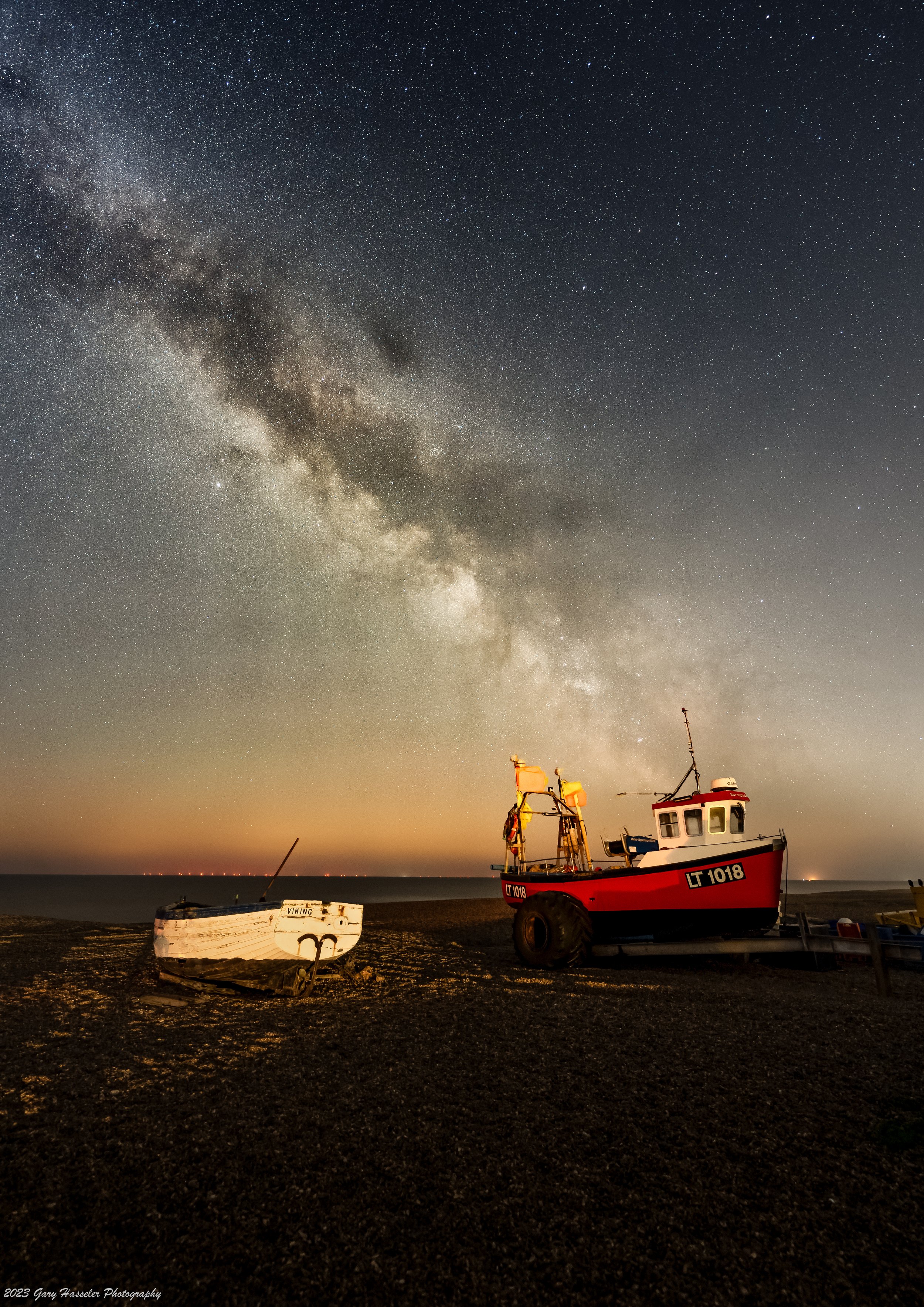 The Milky Way over boats on Aldeburgh beach, Suffolk. April.