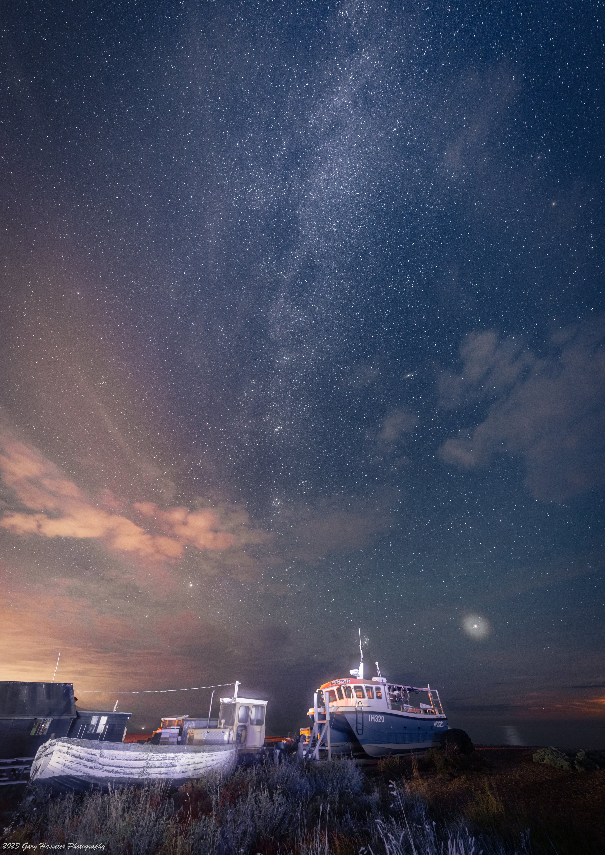 A summer Milky Way over boats on Aldeburgh beach, Suffolk. August.
