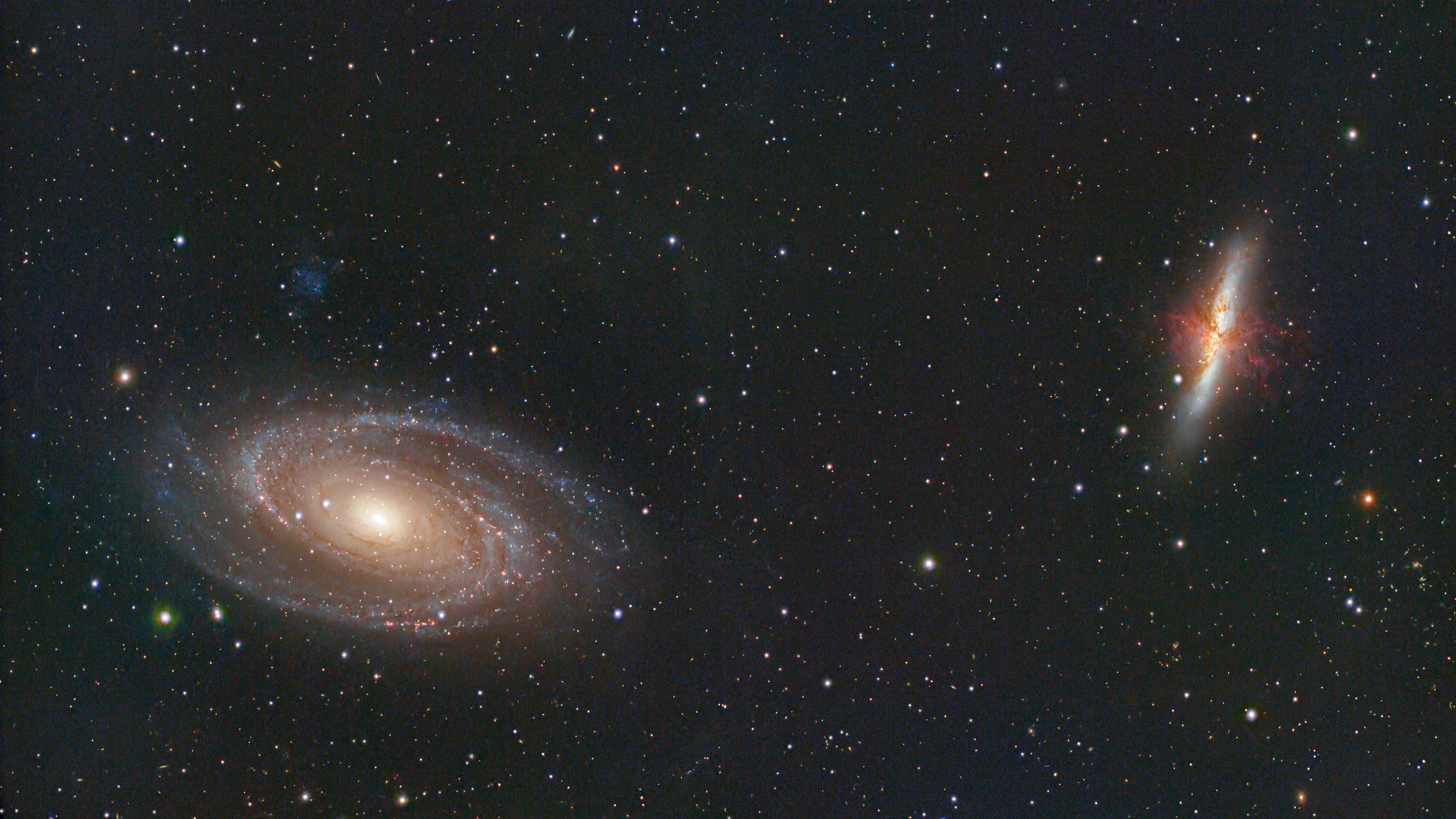 M81: Bode's galaxy (left) and the M82: the Cigar galaxy (right).  The Cigar galaxy is a spectacular starburst galaxy.  It's chaotic shape results from its gravitational interaction with M81 and the intense star forming actions within itself.
