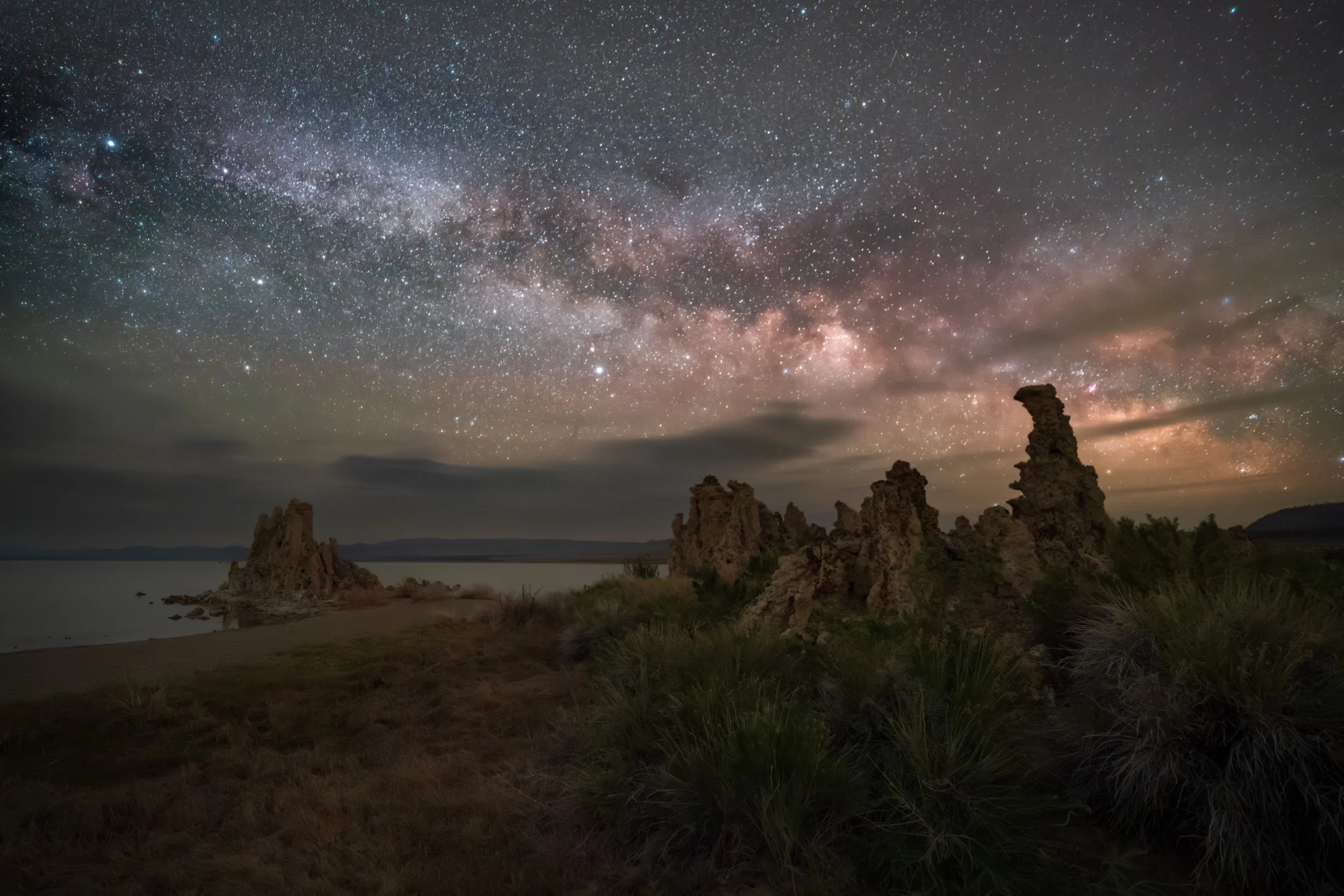 The Milky Way rises over Mono Lake, California.  Towers of limestone tufa characterize the lake, which is high in alkalinity.