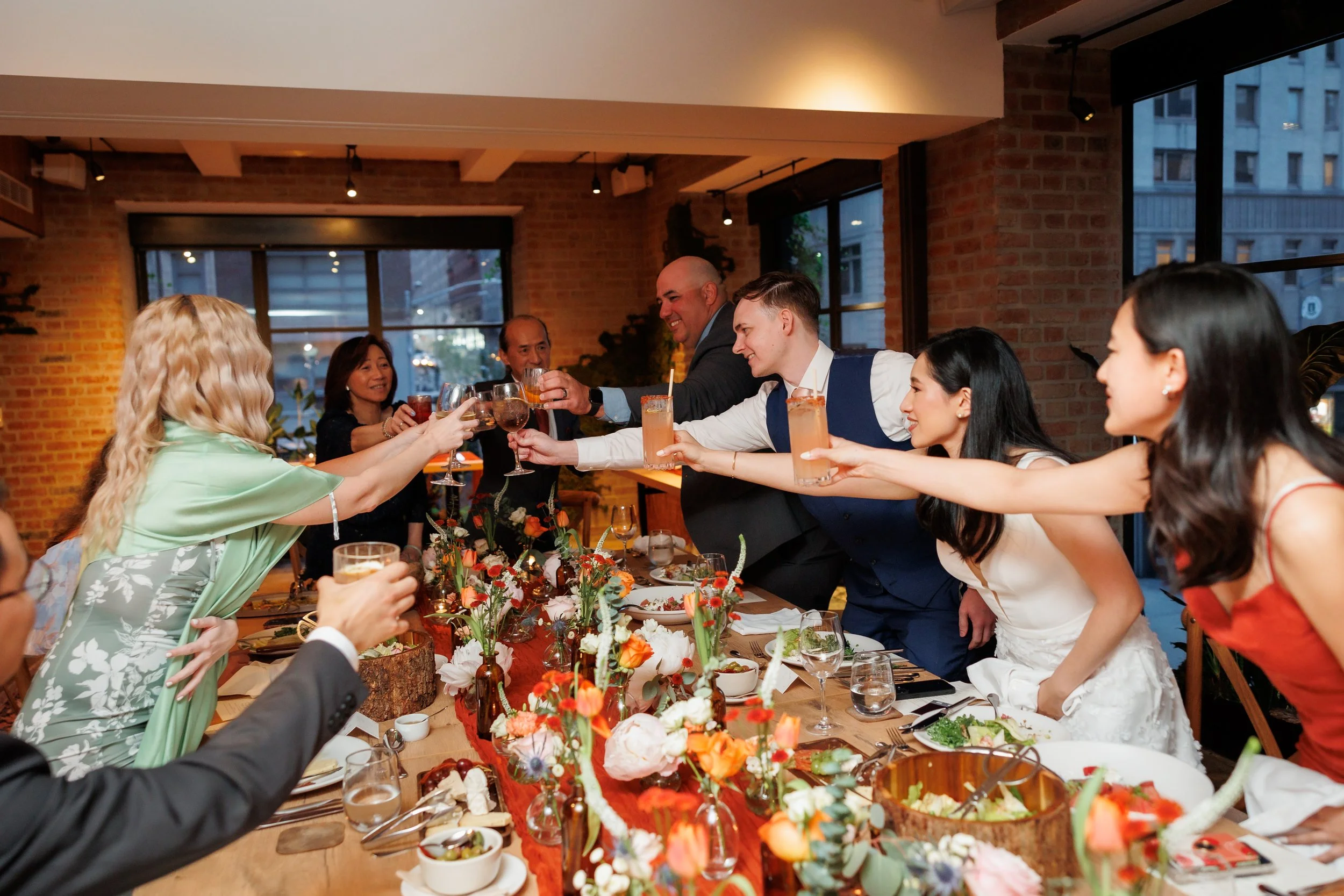 guests raise a glass during toasts at a microwedding at One Hotel Central Park