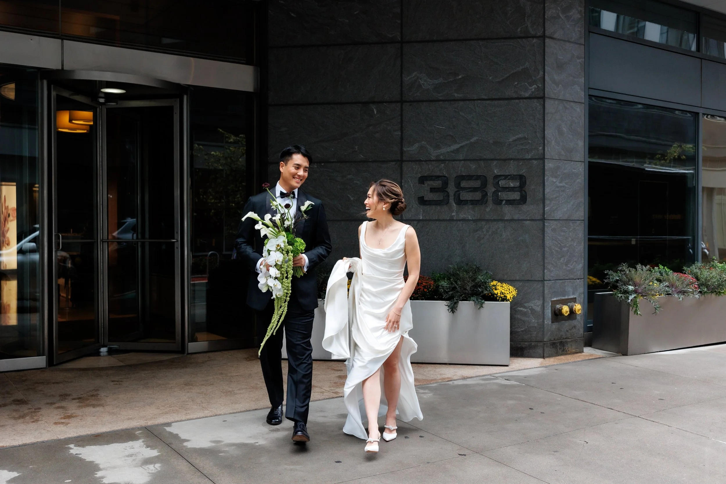  Couple walks down the sidewalk to travel to Ace Hotel Brooklyn for their wedding 