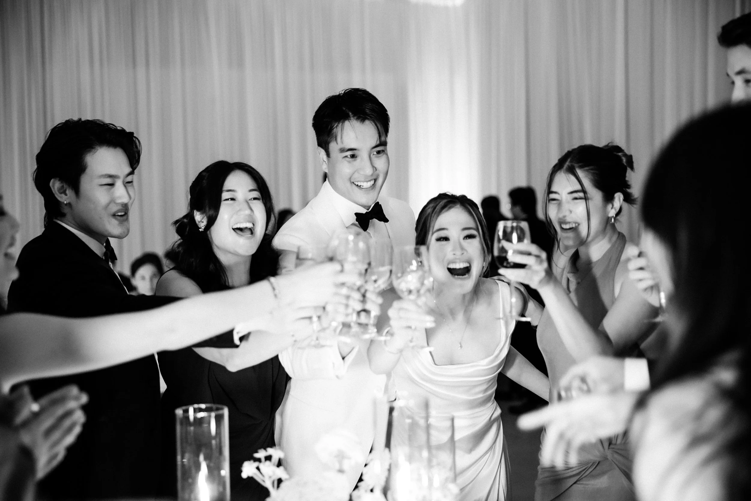  Couple toasting their guests with drinks during their wedding reception 