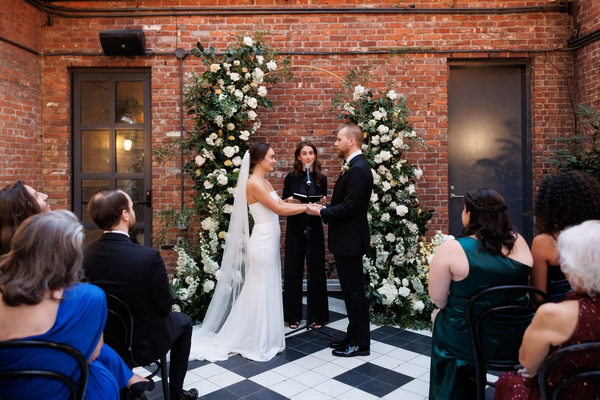  Couple exchanging vows during a wedding ceremony at the wythe hotel 