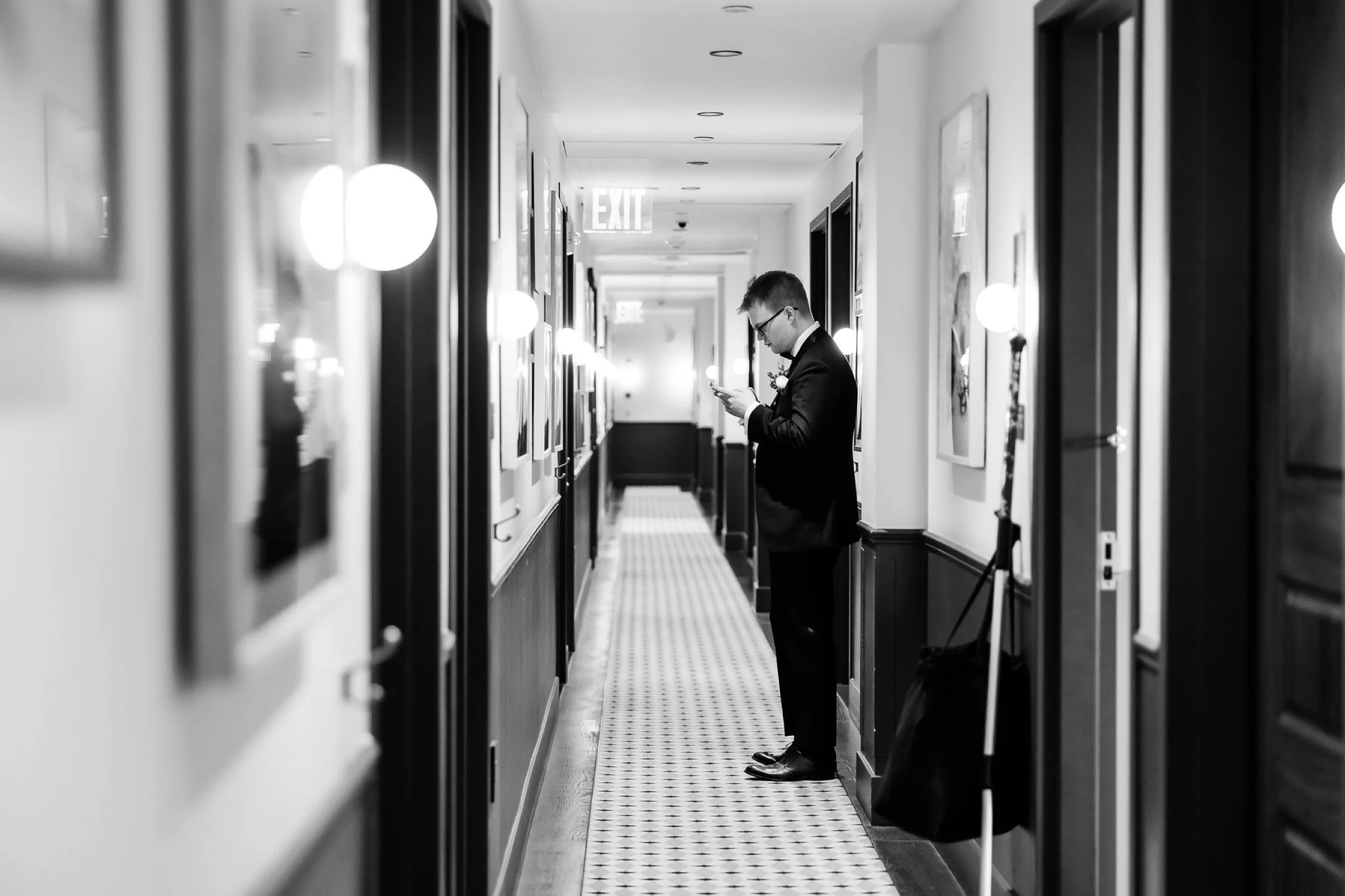 Groom waits in hallway reading vows