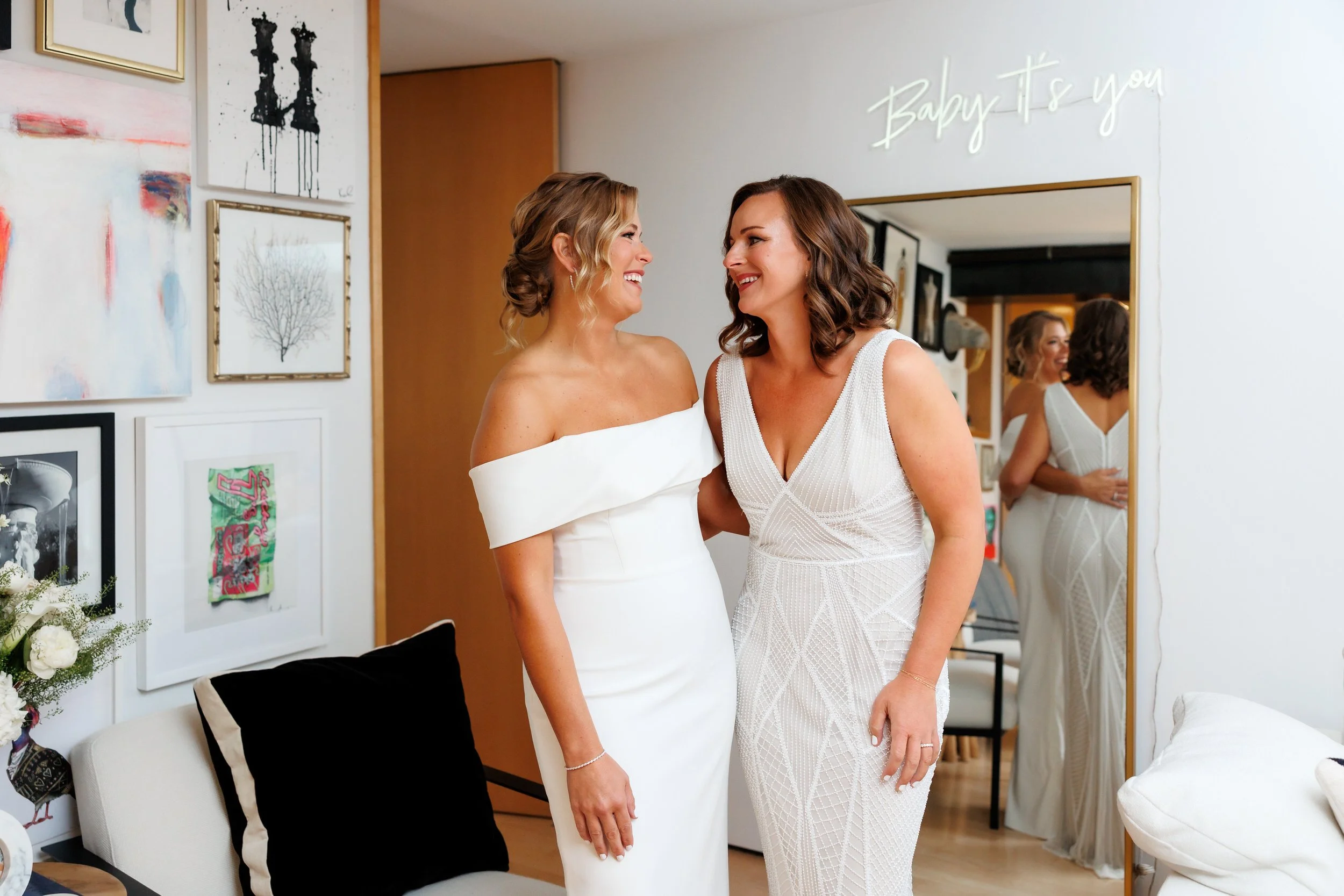 Newlyweds laughing together with their arms around each other's backs 