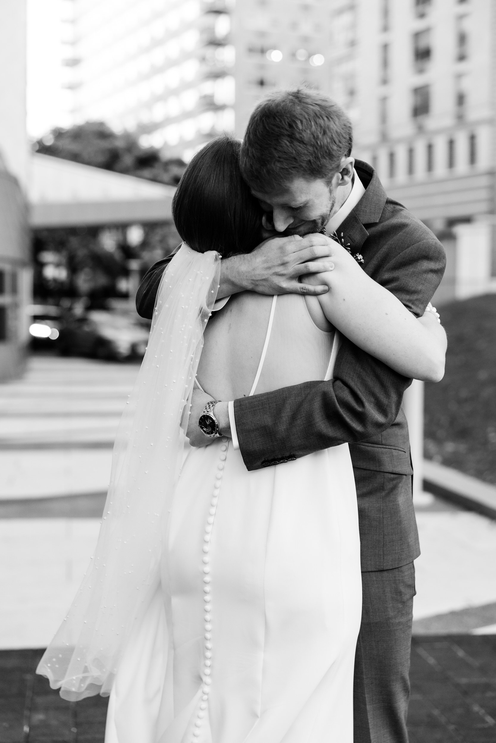 A newlywed couple hugging tightly 